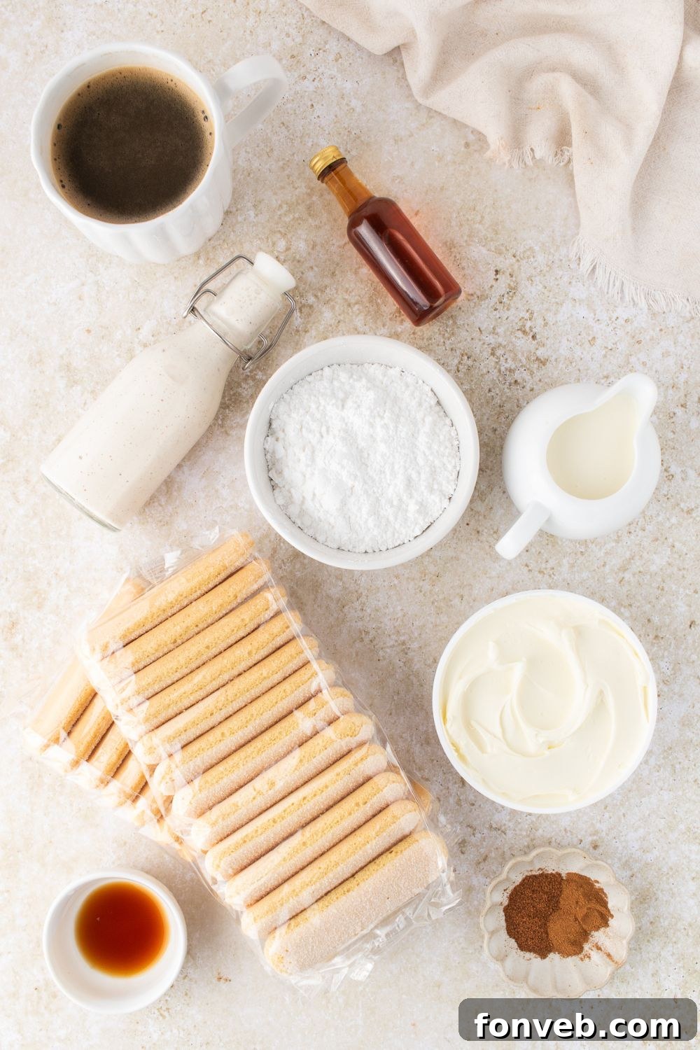 ingredients to make eggnog tiramisu in single serve white bowls on a white counter