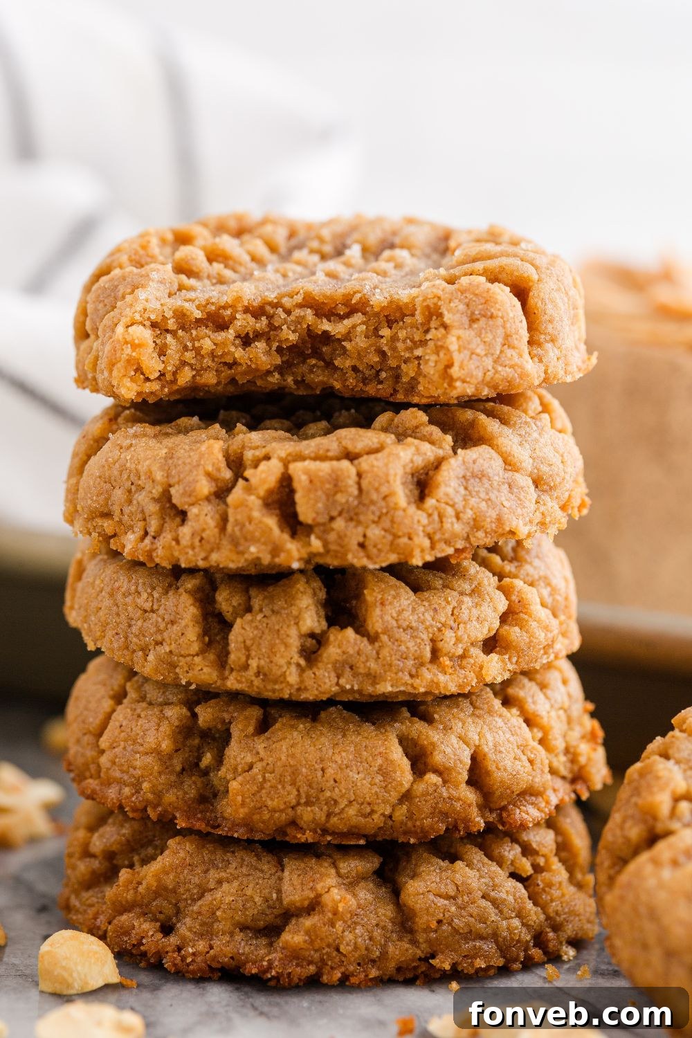 Easy 4-Ingredient Flourless Peanut Butter Cookies 17 stack of peanut butter cookies with a bite taken out of the top of the cookie