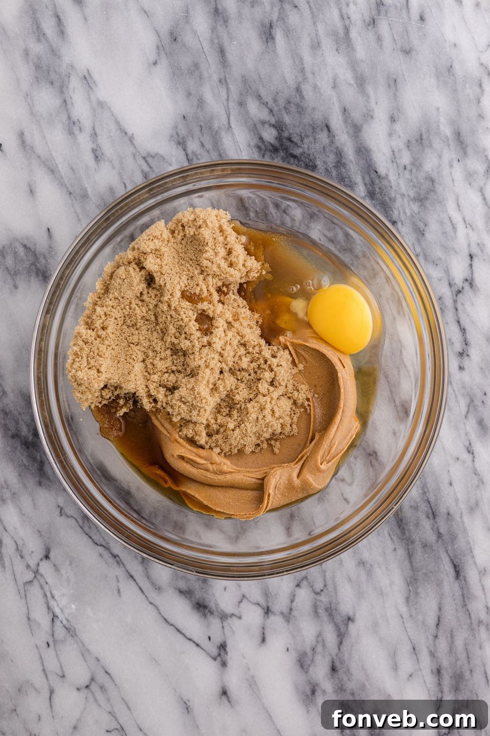 Easy 4-Ingredient Flourless Peanut Butter Cookies 6 peanut butter and egg mixture in a glass bowl