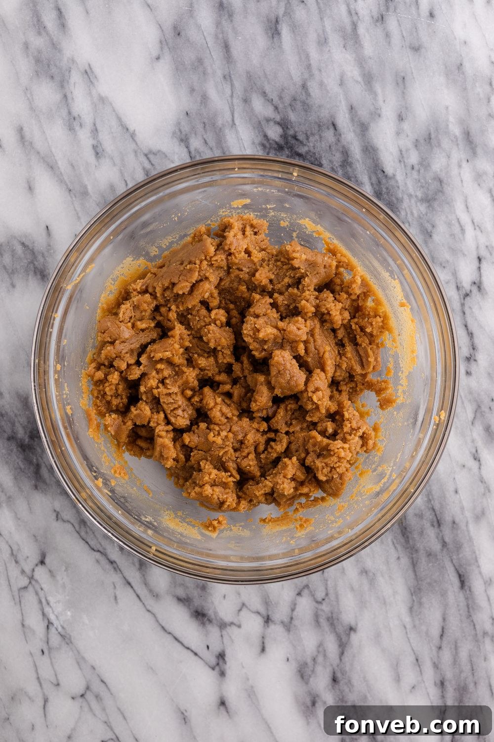 Easy 4-Ingredient Flourless Peanut Butter Cookies 7 a glass bowl of peanut butter mixture