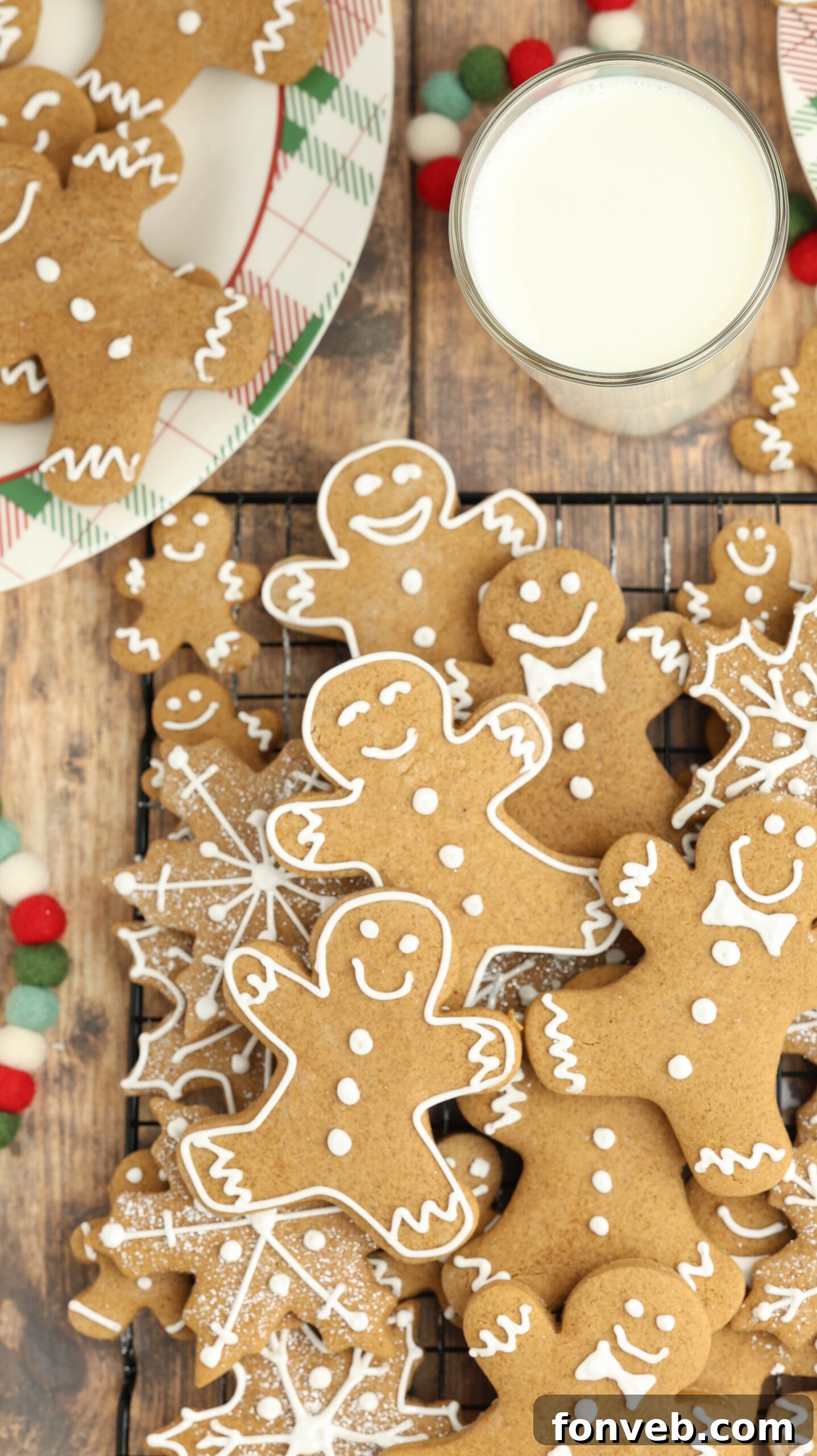 Dazzling Christmas Gingerbread Adorned With Royal Icing 18 overhead shot of a cooling rack with Christmas gingerbread cookies and a big cup of milk