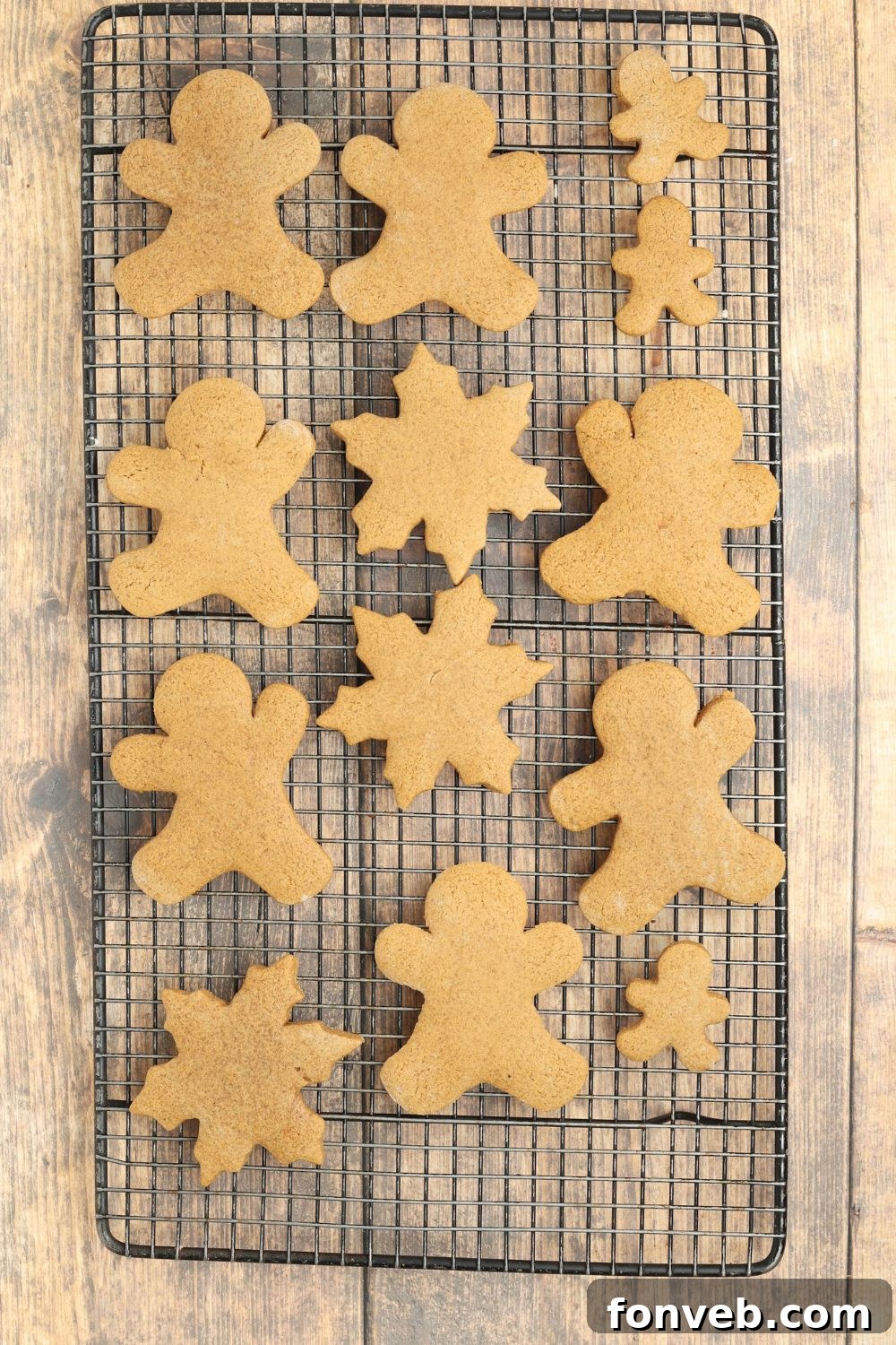 Dazzling Christmas Gingerbread Adorned With Royal Icing 8 baked Christmas gingerbread cookies on a cooling rack on table