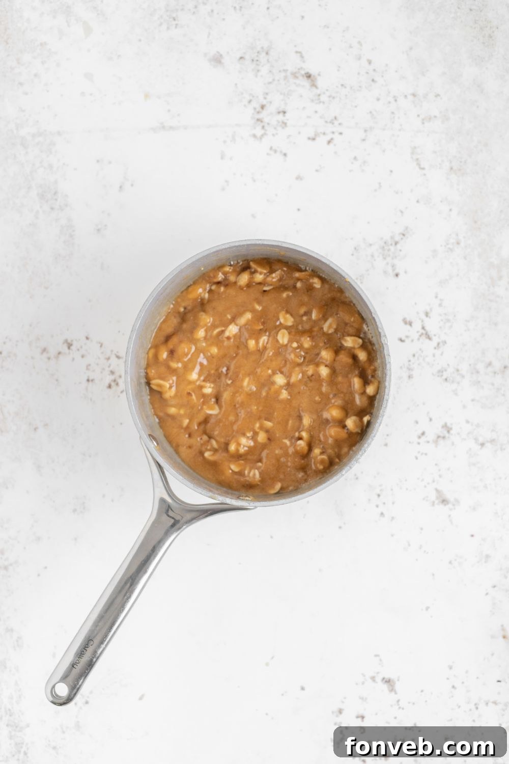 Classic Crunchy Peanut Brittle Made Simple 11 saucepan with Homemade Peanut Brittle cooking in it