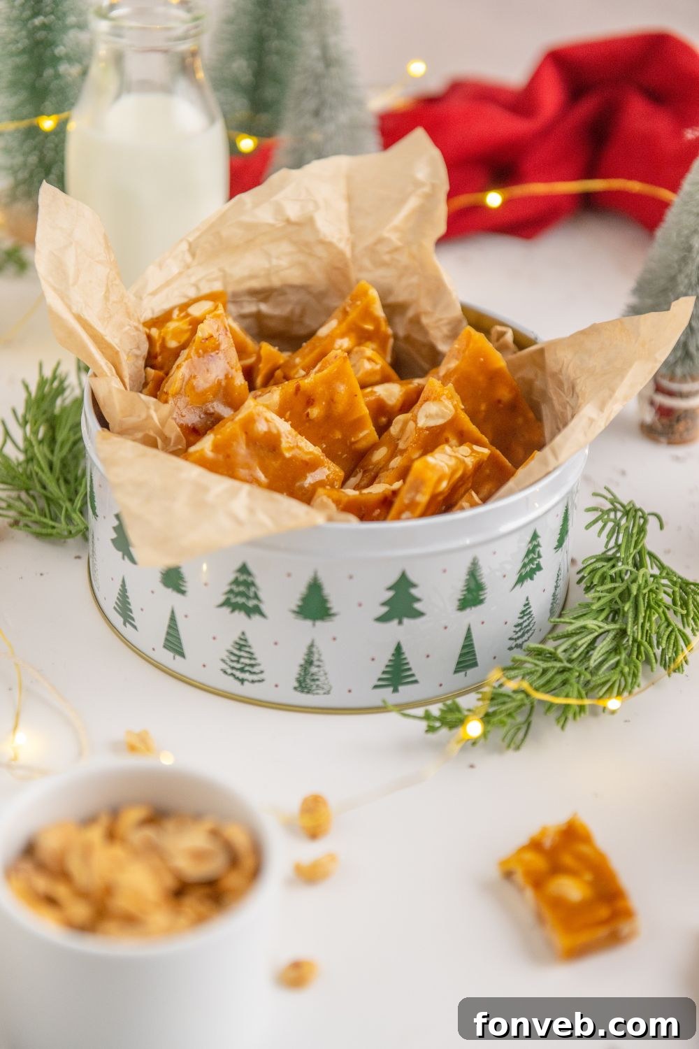 Classic Crunchy Peanut Brittle Made Simple 17 Homemade Peanut Brittle on table in a tin and more brittle around the table