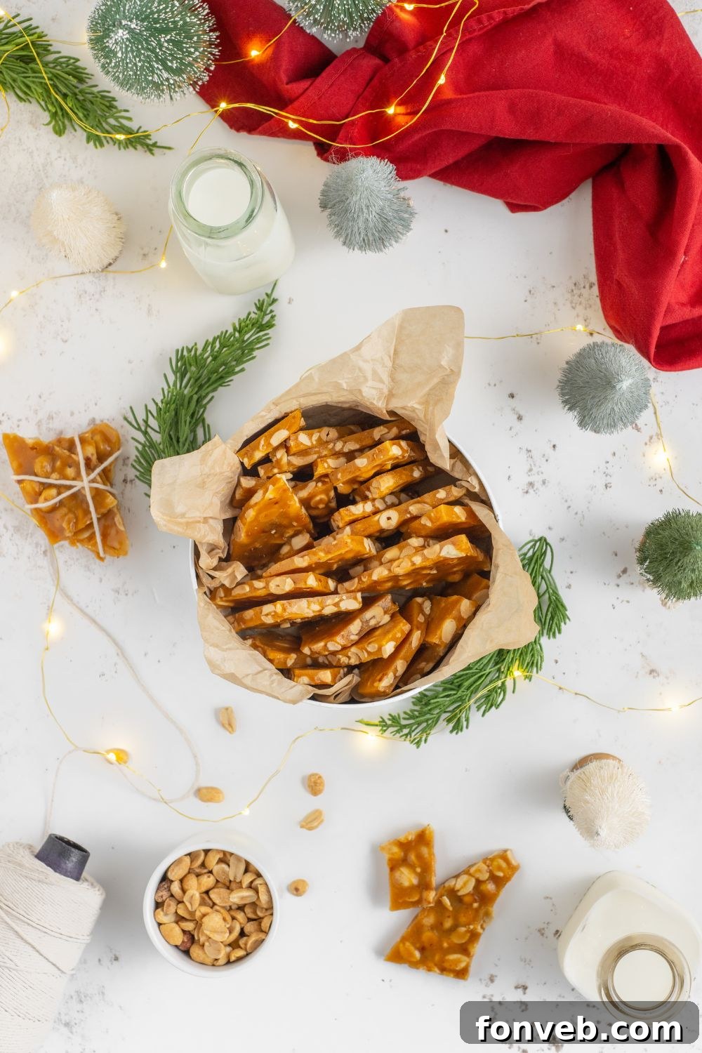 Classic Crunchy Peanut Brittle Made Simple 3 A Christmas decorated table with ornaments and such and in the center is a tin full of Homemade Peanut Brittle