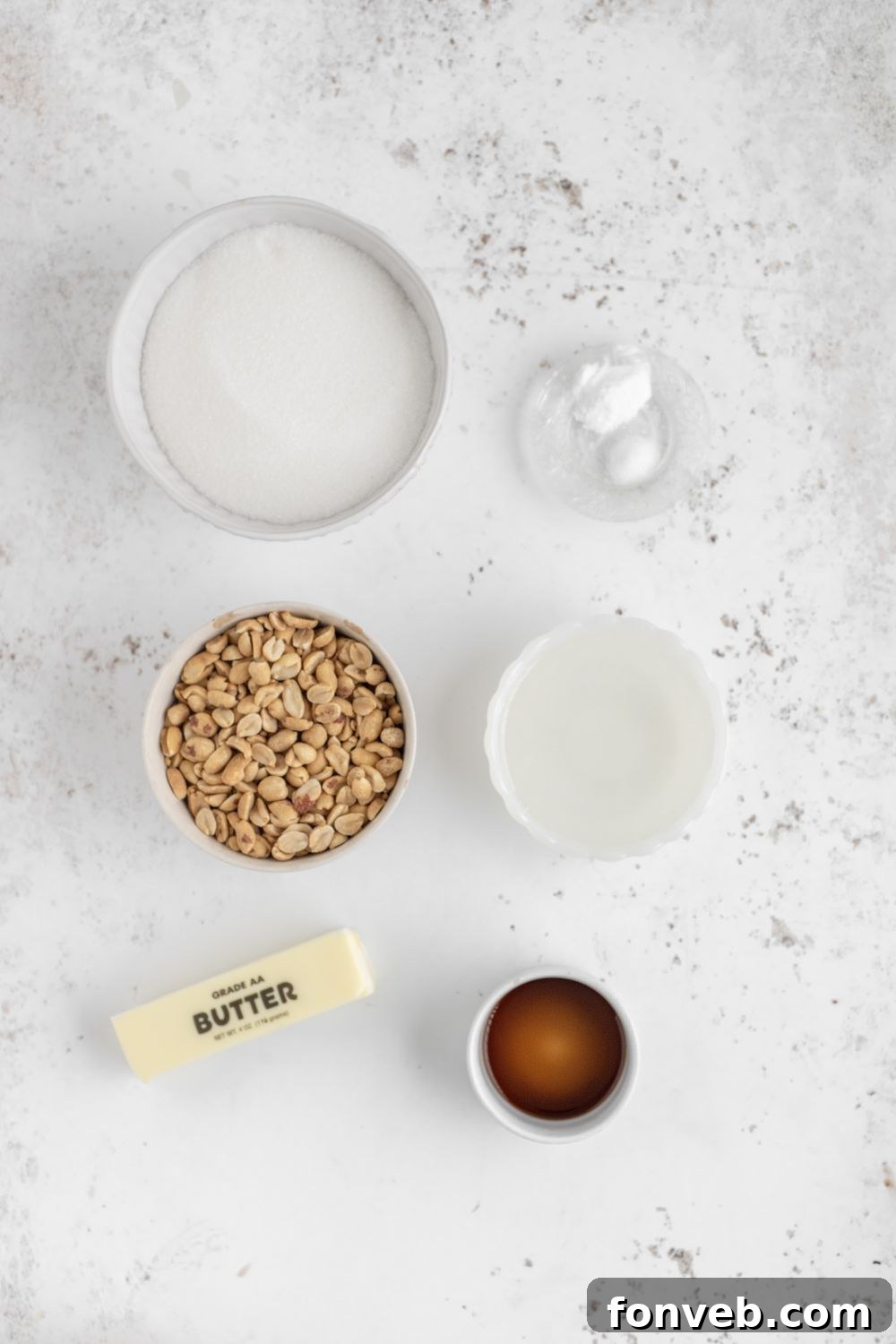 Classic Crunchy Peanut Brittle Made Simple 5 all the ingredients for Homemade Peanut Brittle in small glass bowls on table