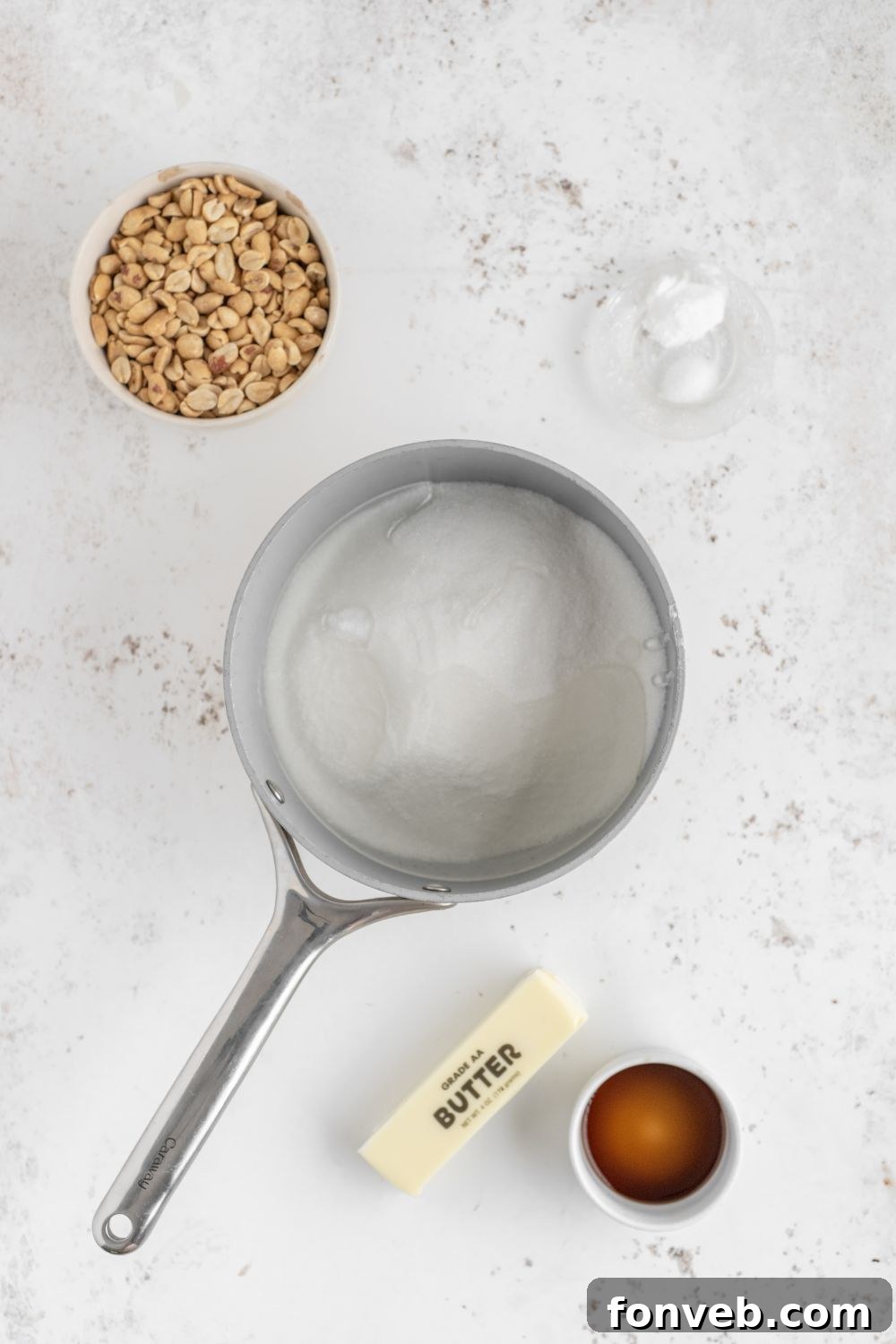 Classic Crunchy Peanut Brittle Made Simple 6 sugar in a saucepan with other ingredients to make brittle around table