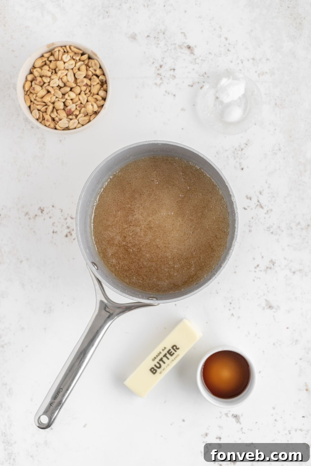 Classic Crunchy Peanut Brittle Made Simple 8 prep of making Homemade Peanut Brittle in a saucepan with butter, vanilla and nuts to side