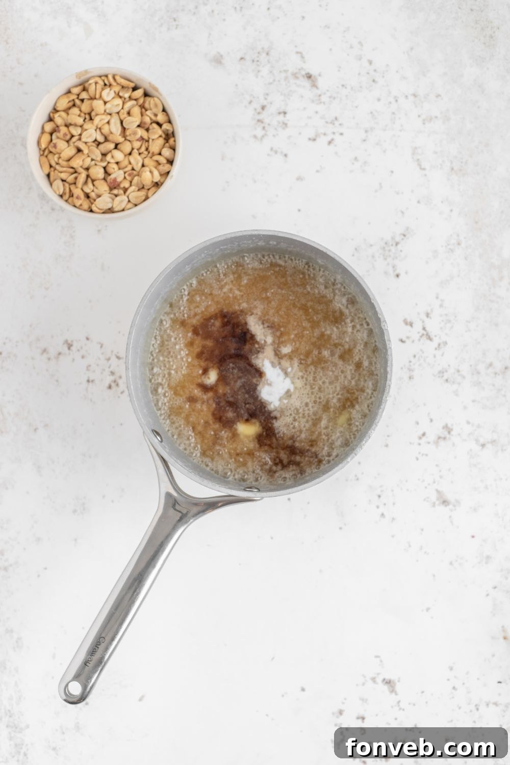 Classic Crunchy Peanut Brittle Made Simple 9 process of making Homemade Peanut Brittle with peanuts in a bowl to side