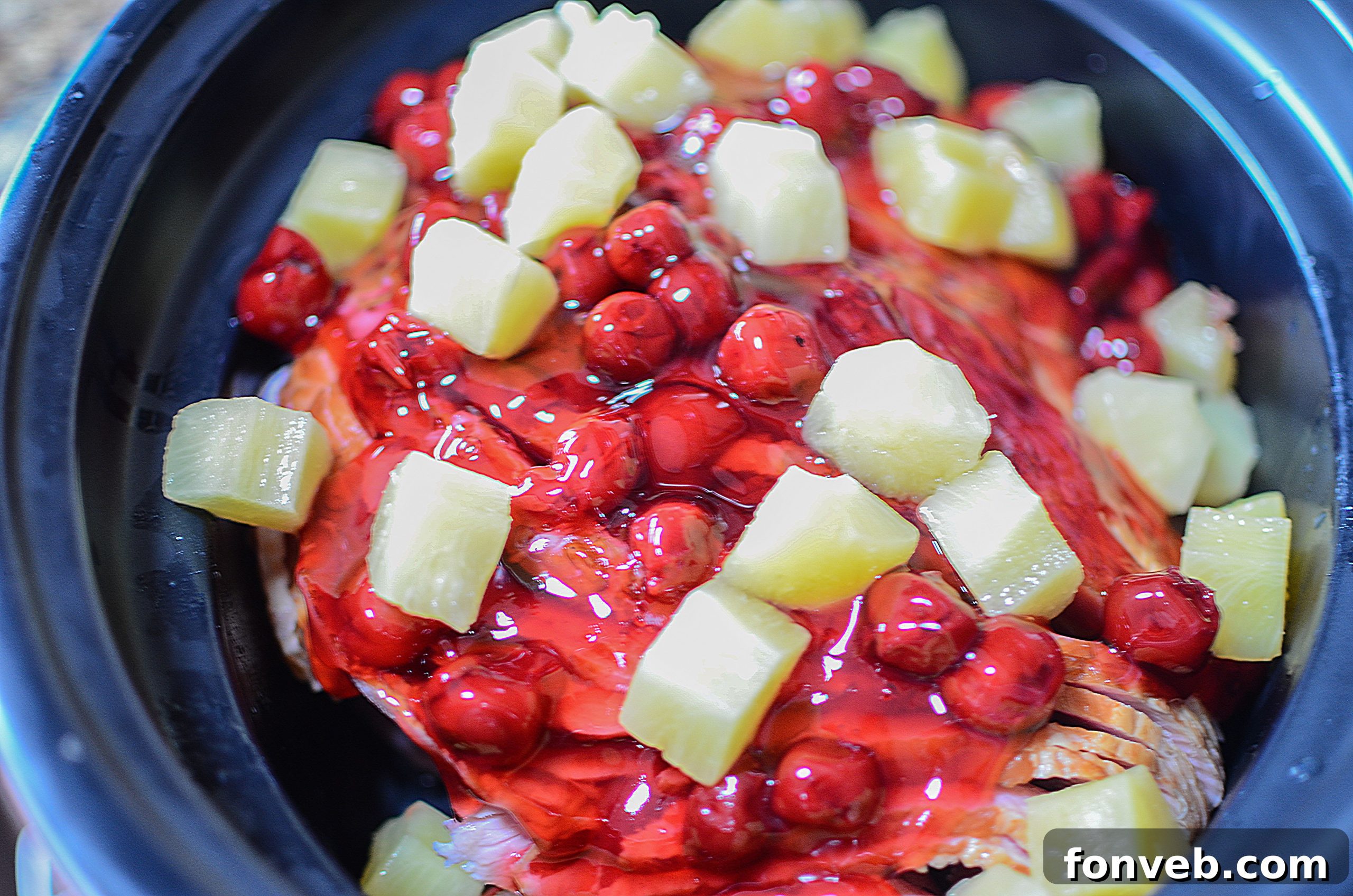 Slow Cooker Caramelized Pineapple Ham 4 Preparing the ham in a slow cooker with pineapple and cherry pie filling.