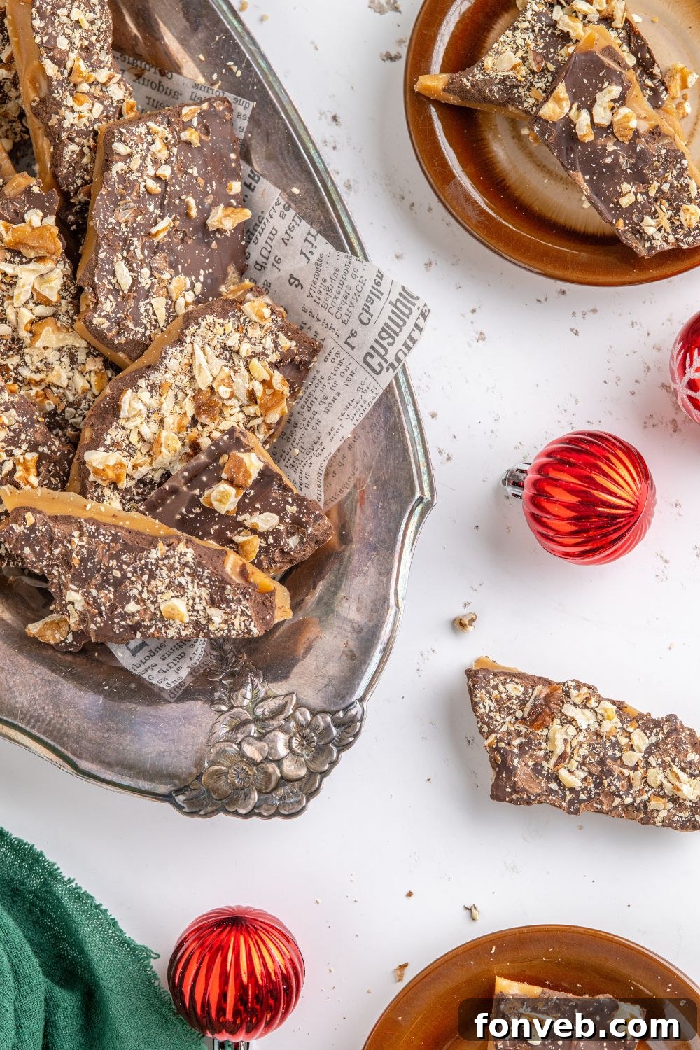 English Toffee on a platter with Christmas ornaments around the table 