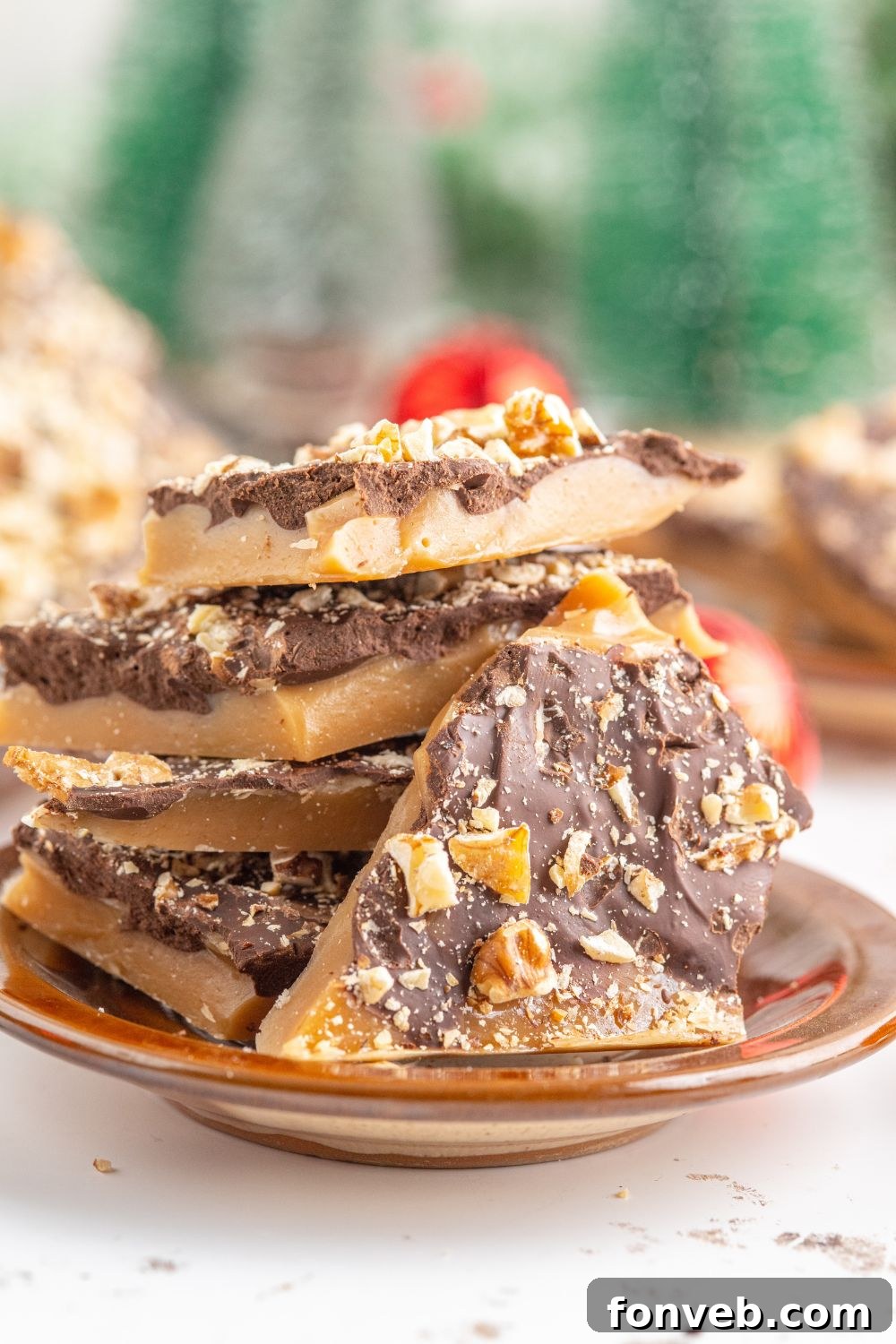 English Toffee on table with Christmas trees behind it on table 