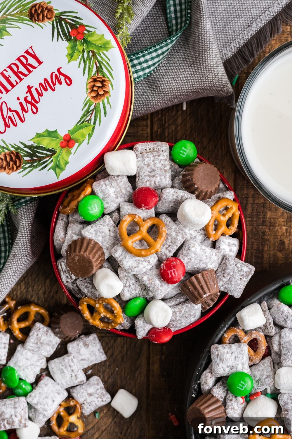Christmas Chex Mix in bowls on table with more scattered around table and a decorative Christmas tin 