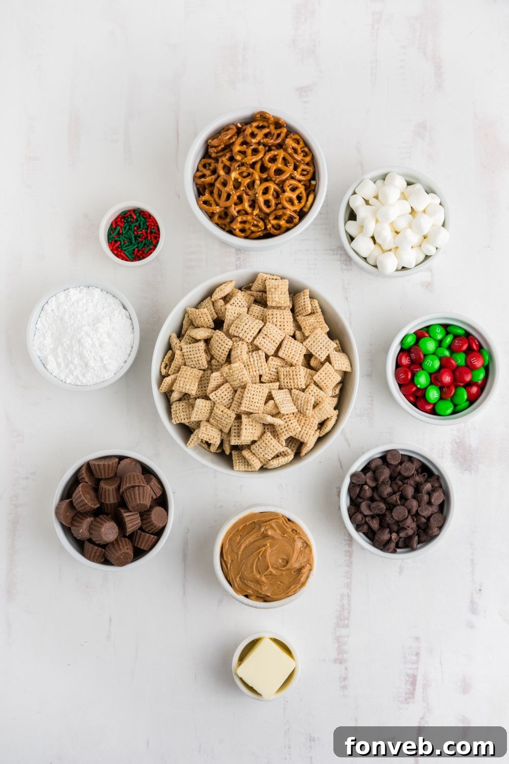 alll ingredients for puppy chow and chex mix in single serve bowls on table 