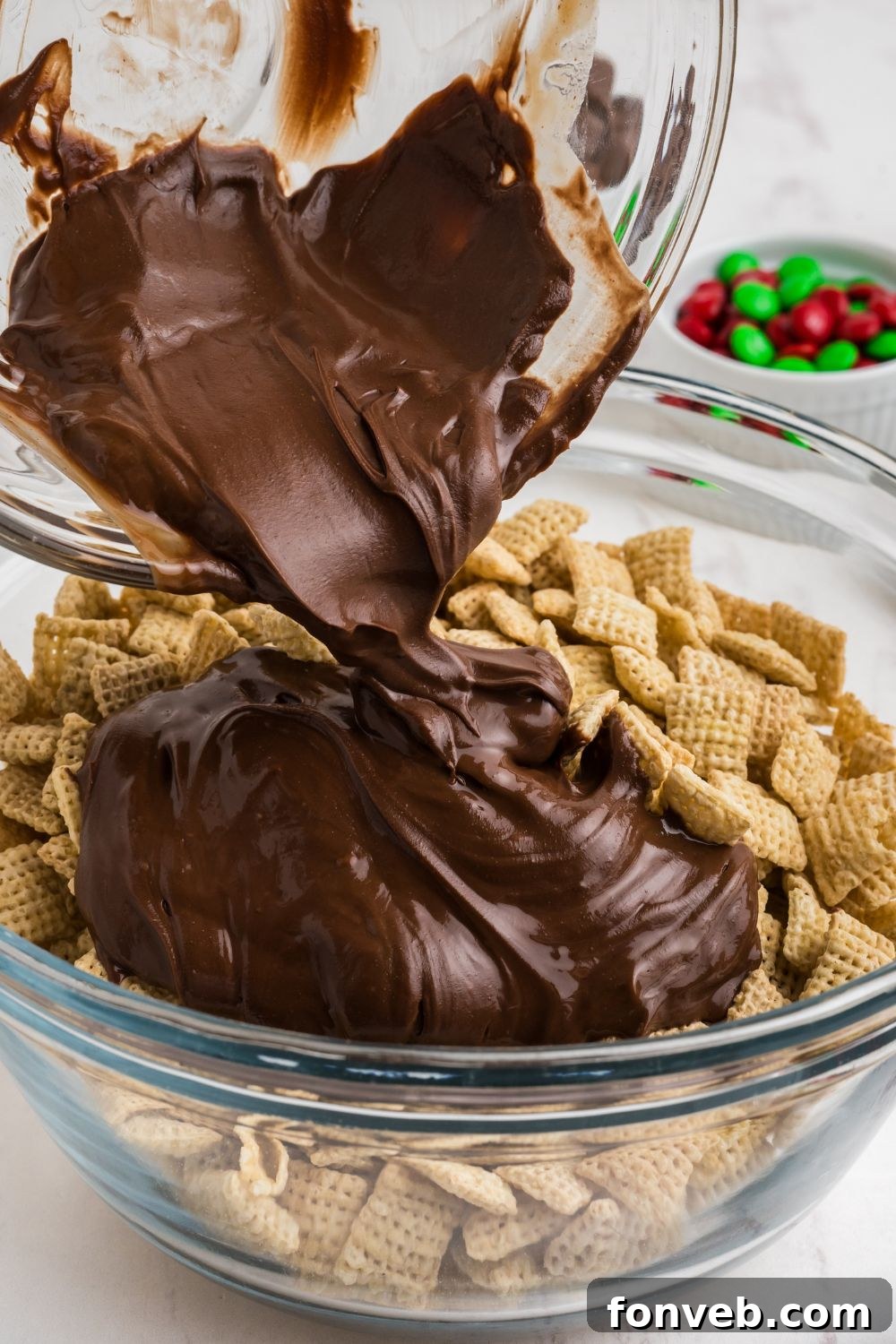 chocolate mixture pour in a bowl with chex cereal 