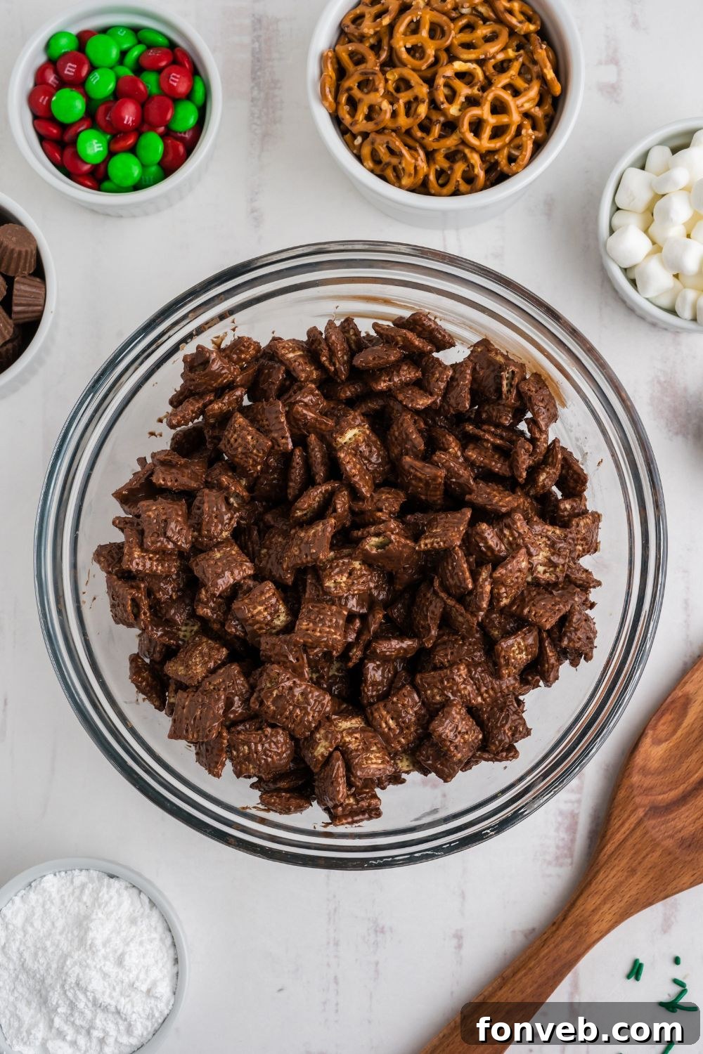 chocolate coated chex cereal in a glass bowl on table 