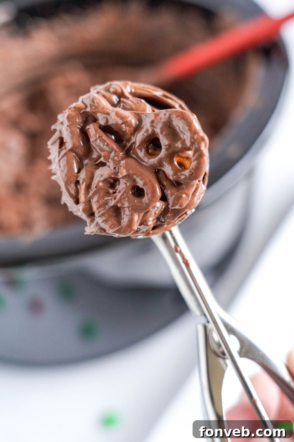 Sweet and Salty Slow Cooker Holiday Clusters 12 cookie scoop full of Crockpot Chocolate Pretzel Christmas Candy