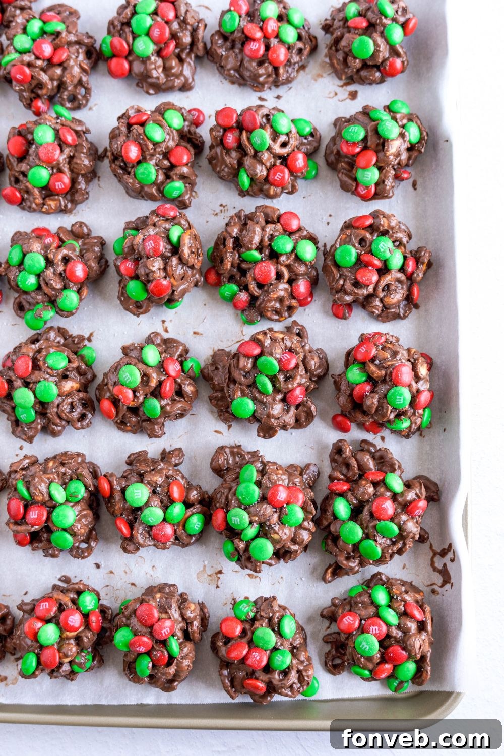 Sweet and Salty Slow Cooker Holiday Clusters 15 Crockpot Chocolate Pretzel Christmas Candy scooped into piles on a cooling tray