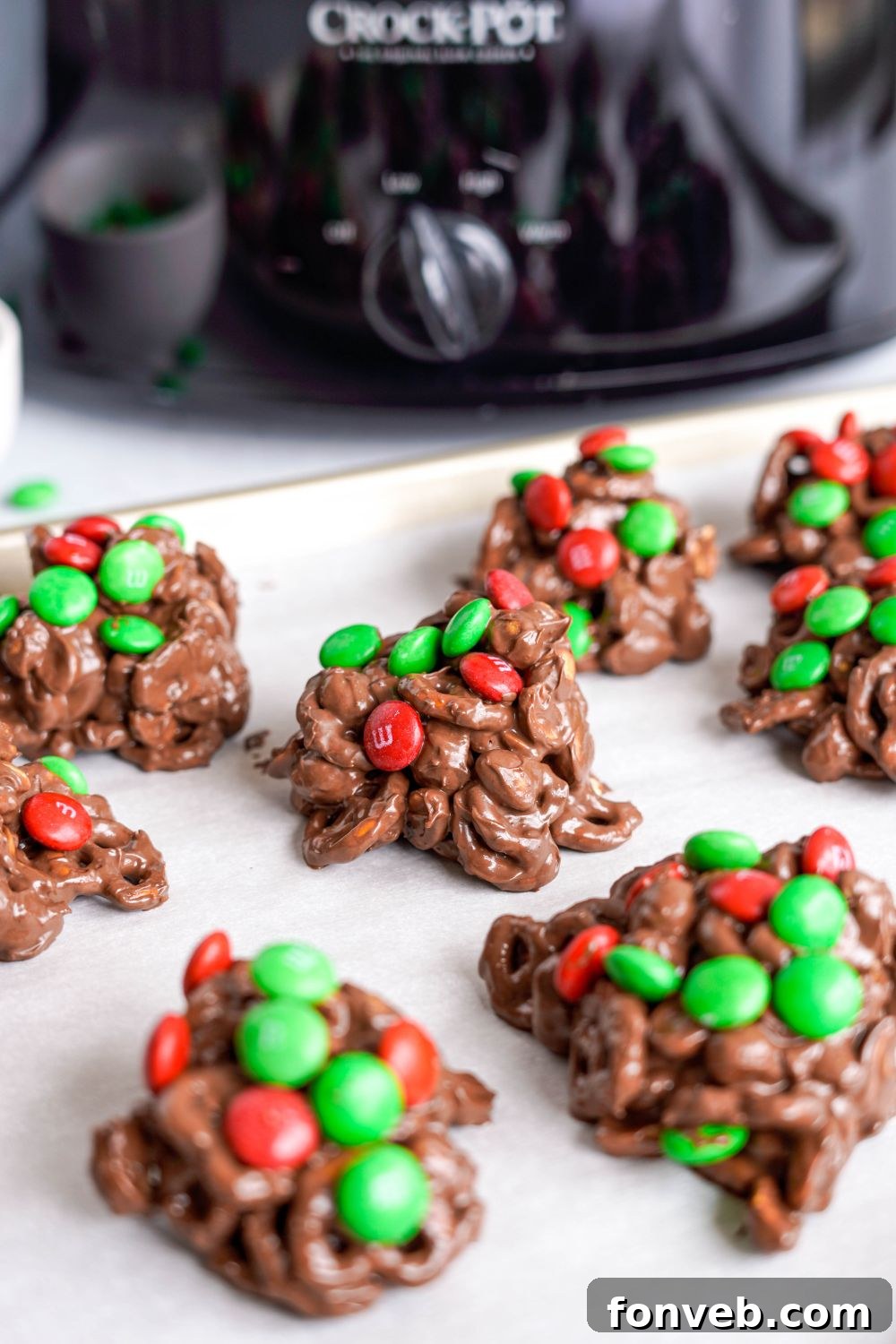 Sweet and Salty Slow Cooker Holiday Clusters 16 crockpot with scoops of candy in front