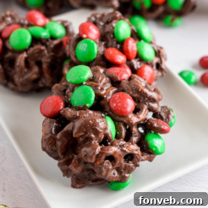 Sweet and Salty Slow Cooker Holiday Clusters 27 Crockpot Chocolate Pretzel Christmas Candy on a white plate on table