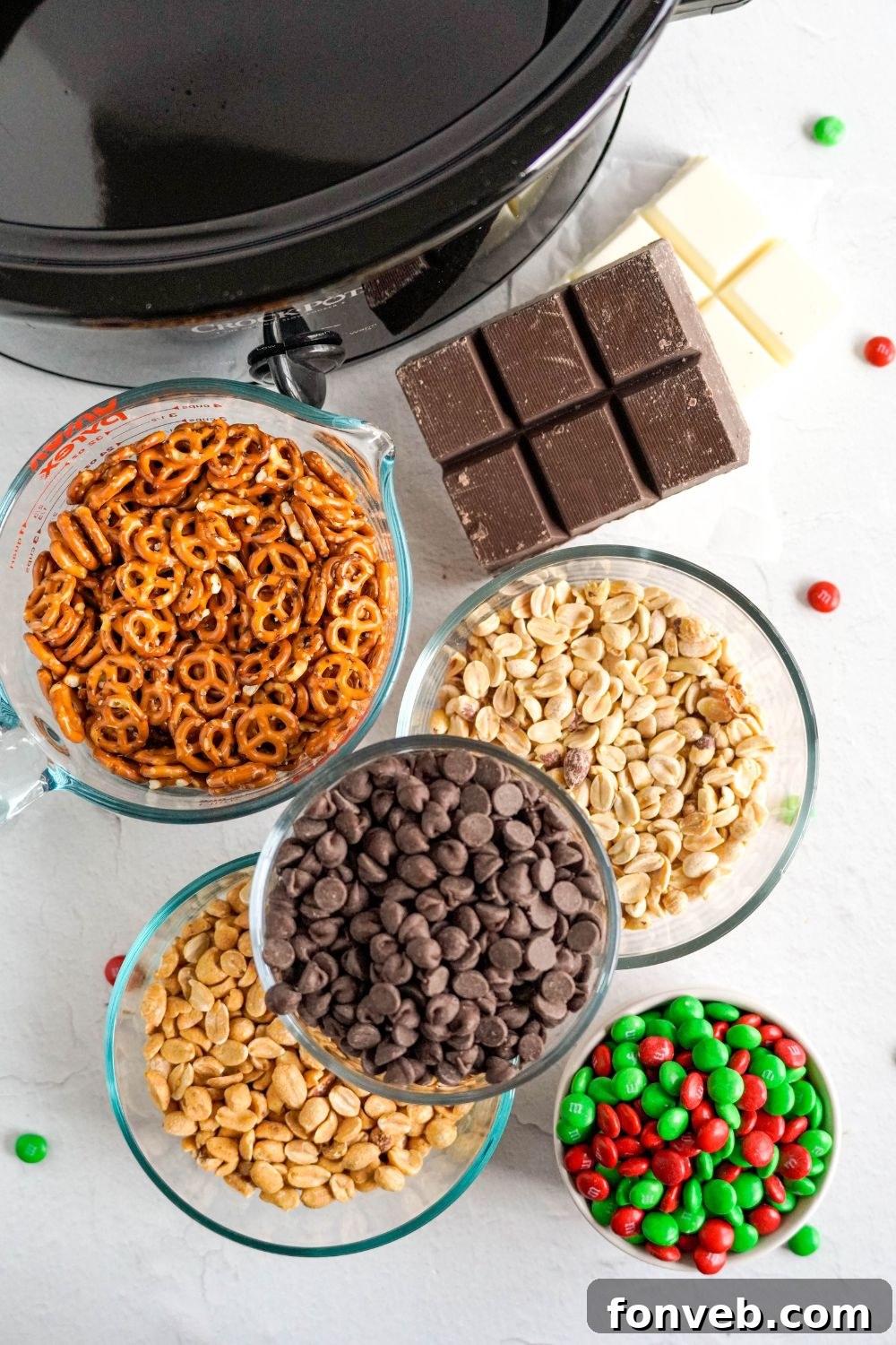 Sweet and Salty Slow Cooker Holiday Clusters 5 crockpot with bowls of all the ingredients to make Crockpot Chocolate Pretzel Christmas Candy