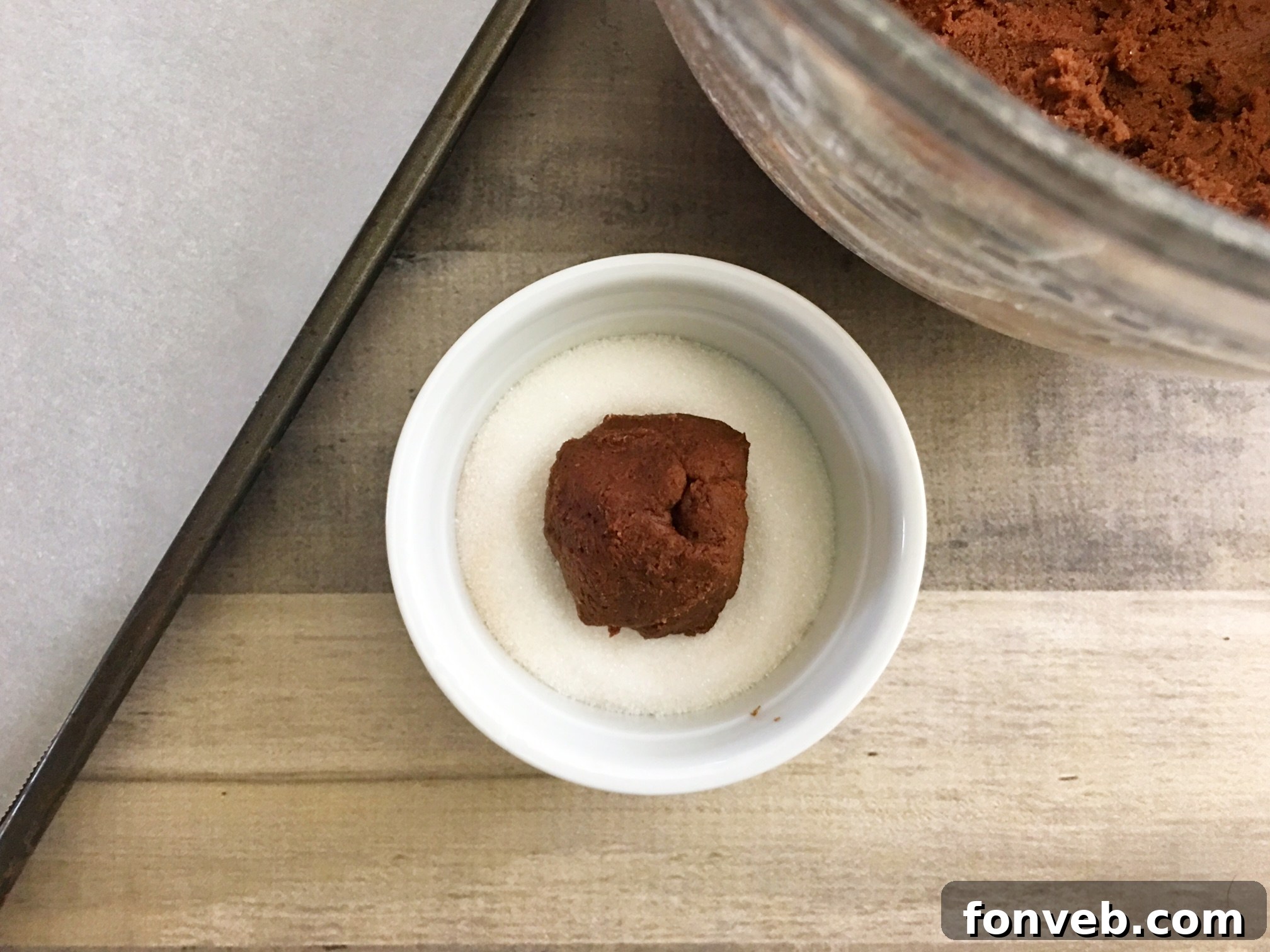 A fresh batch of Hershey's Hugs Blossom Cookies, just removed from the oven, with the white and milk chocolate Hershey's Hugs gently pressed into their warm centers, beginning to melt and create their signature swirl.