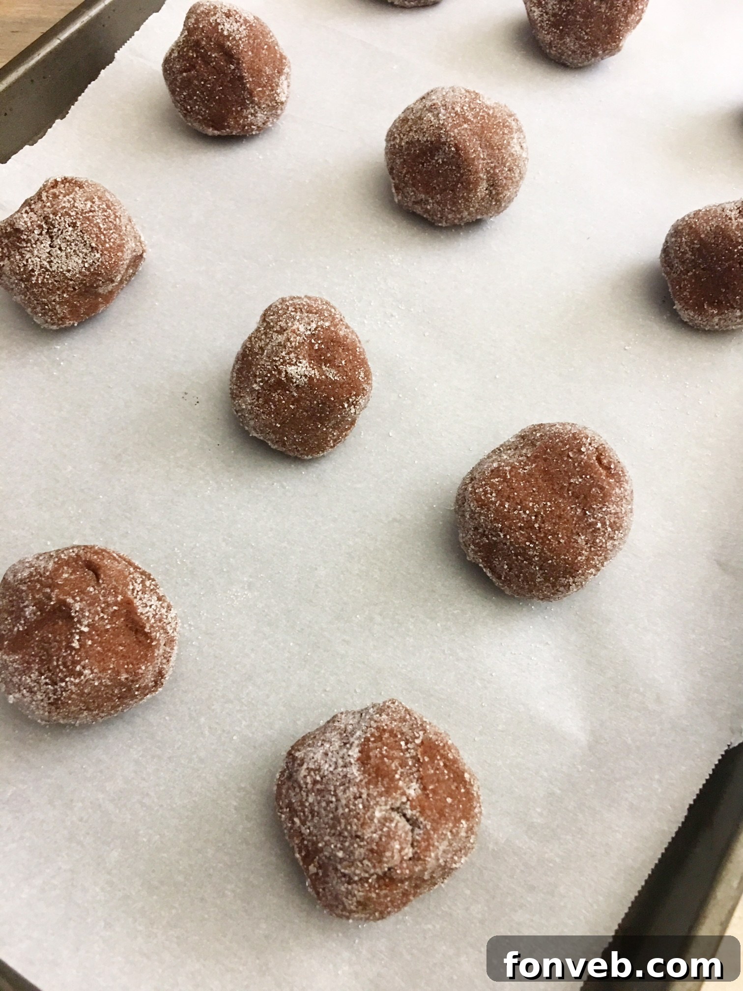 A close-up view of a beautifully stacked collection of Hershey's Hugs Blossom Cookies, featuring their tender, slightly cracked texture and the delightful chocolate kiss on top, perfect for sharing.