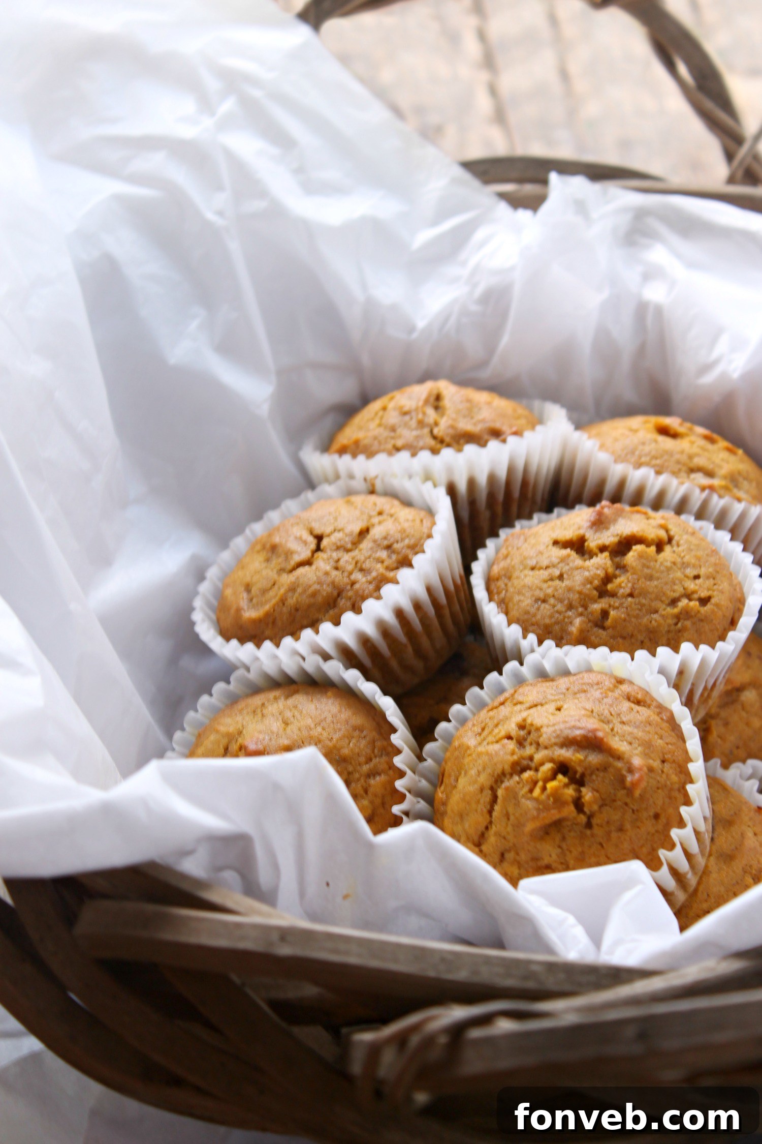 Warm Spiced Butternut Muffins 8 Two butternut squash muffins on a plate, one broken open to show the soft interior.