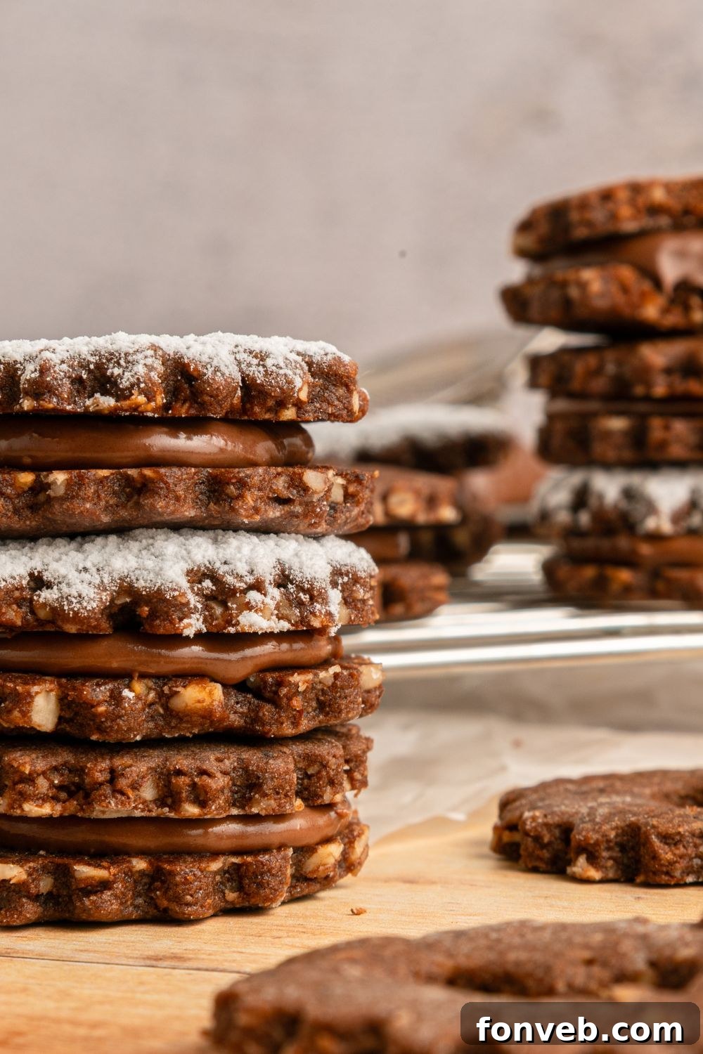 Chocolate Linzer Cookies in stacks around the table 