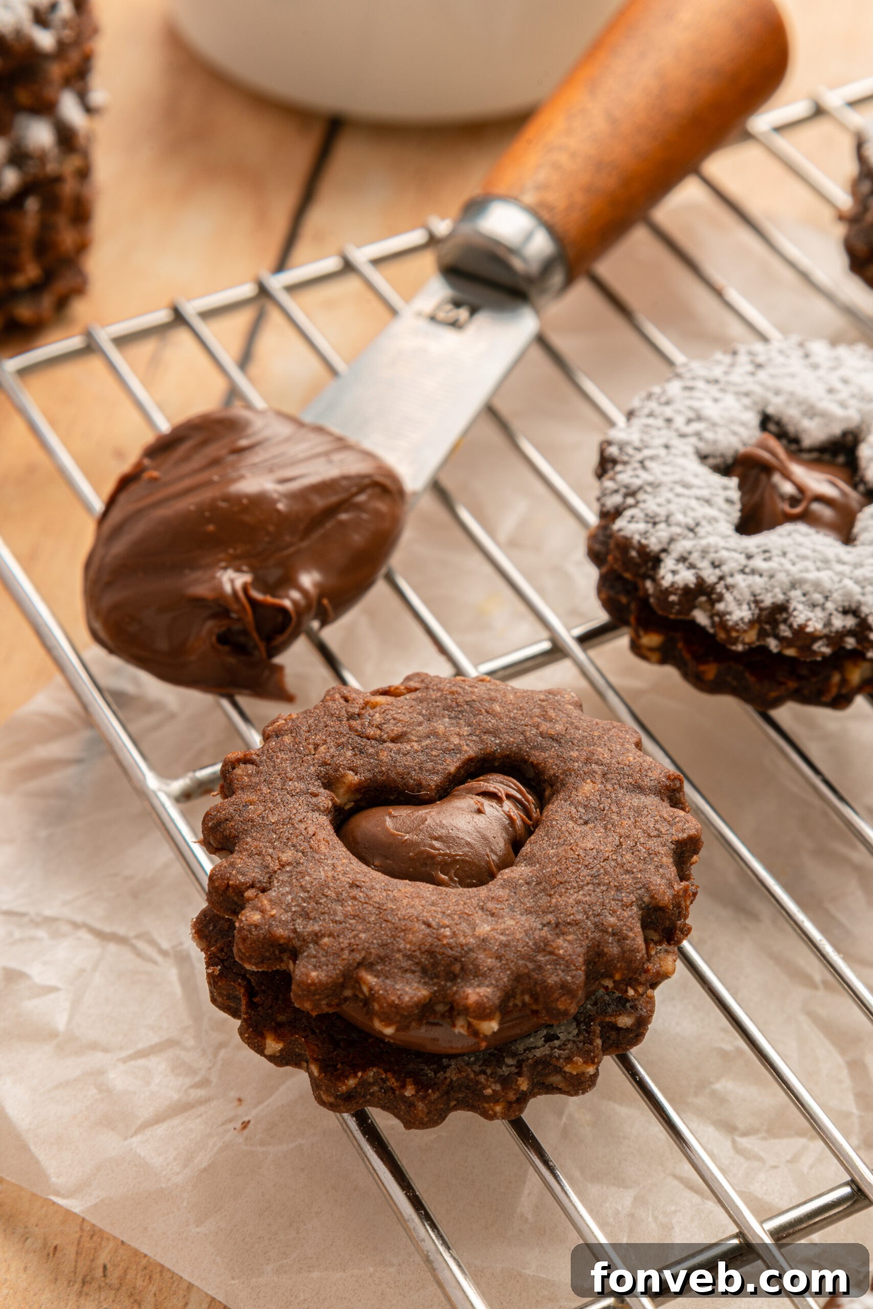 Chocolate Linzer Cookies on a cooling rack without powdered sugar 