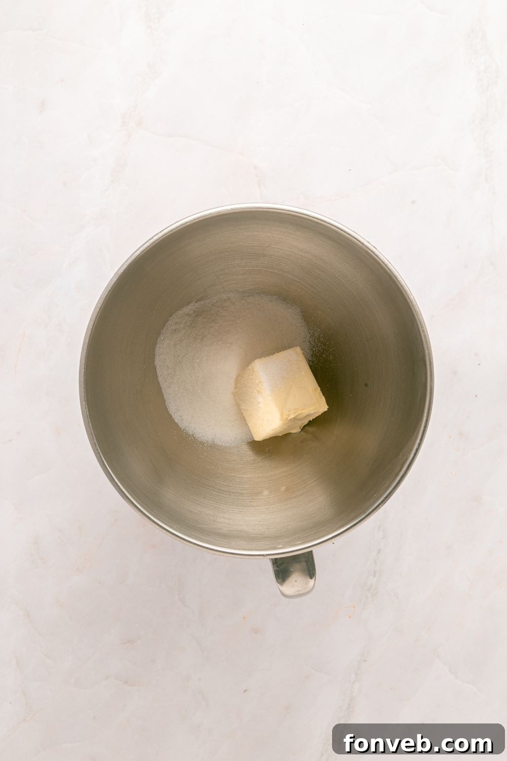 sugar and butter in a metal bowl on table
