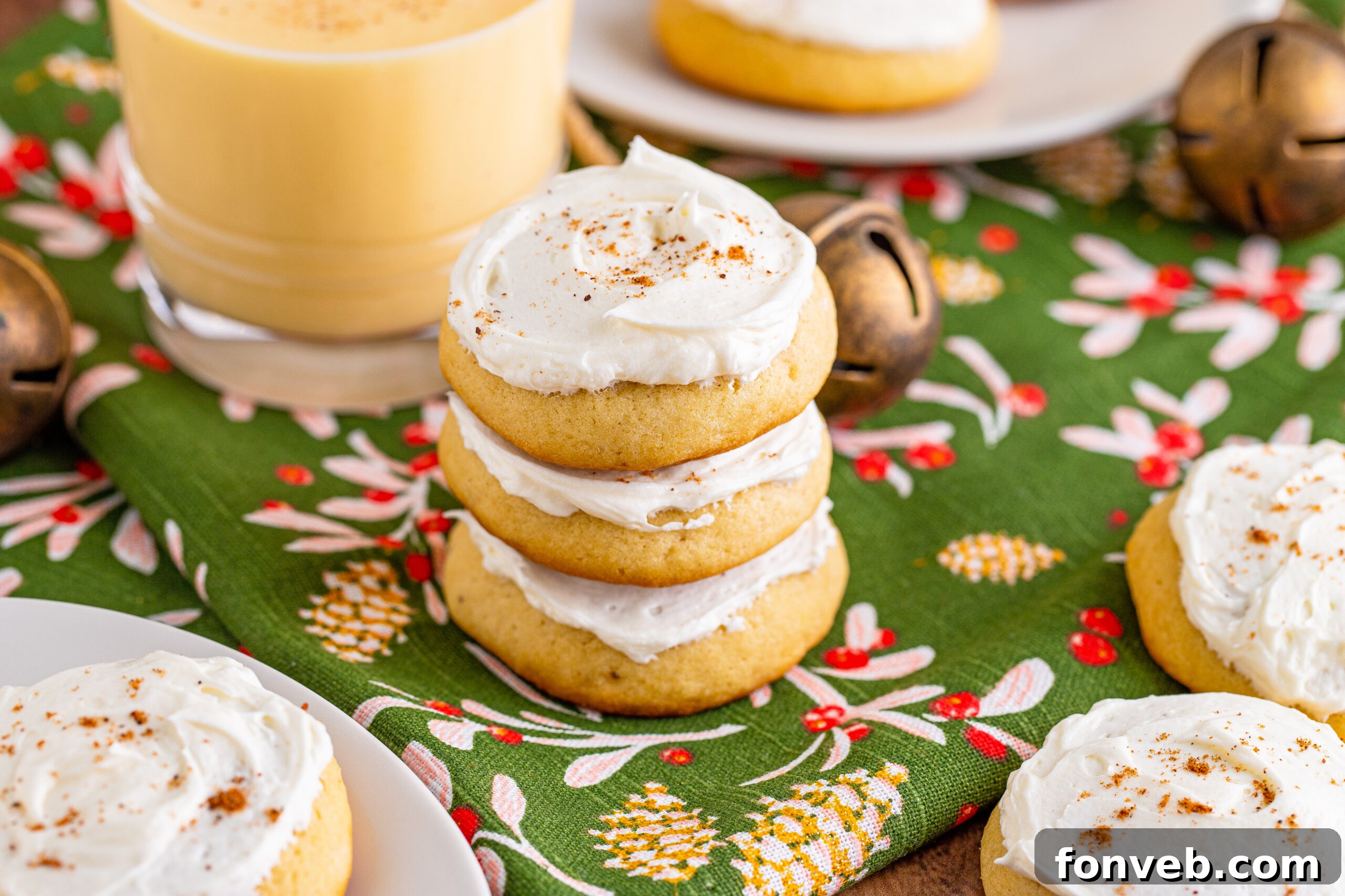 Soft Frosted Eggnog Cookies stacked on a table