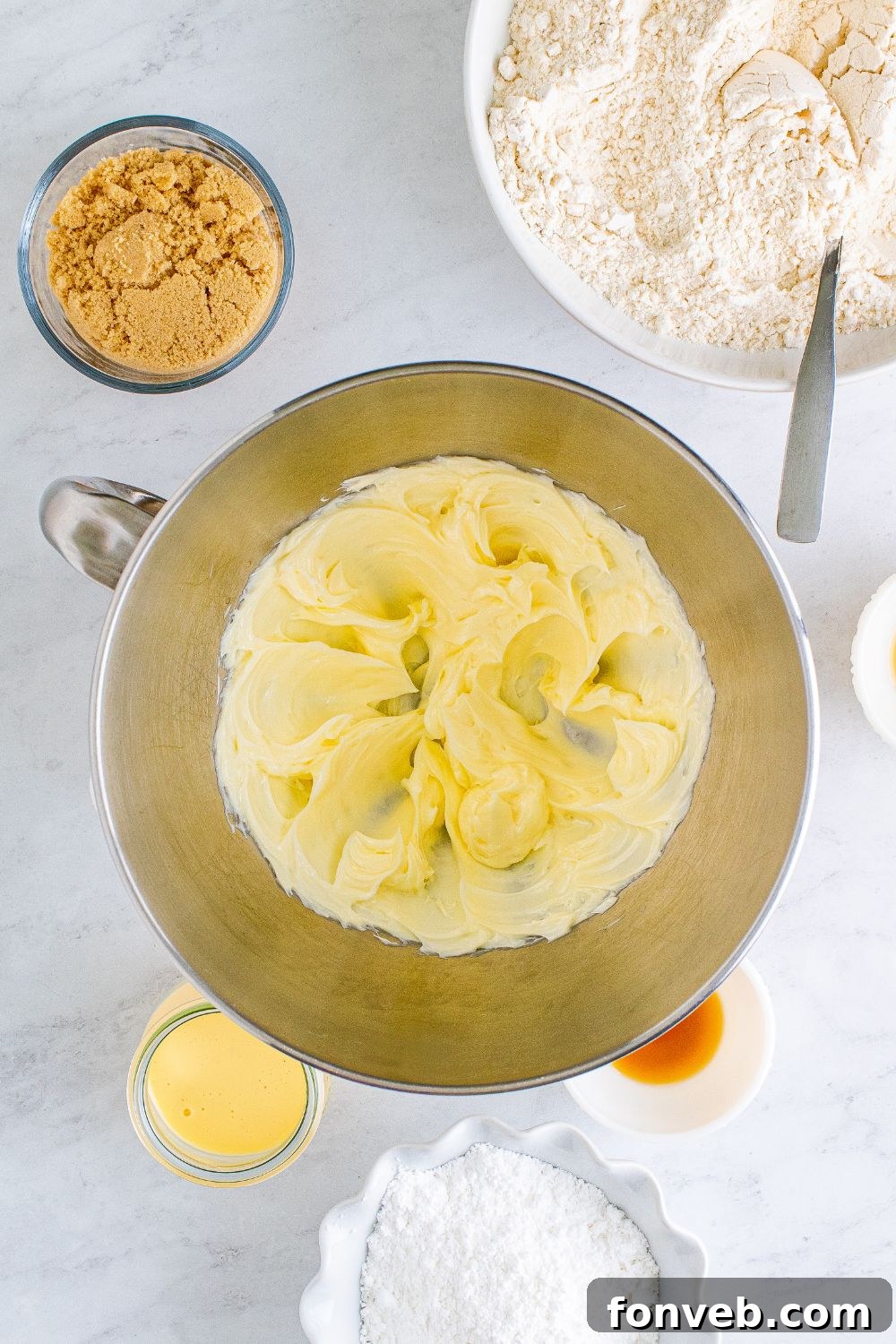 creamed butter in a metal bowl on table