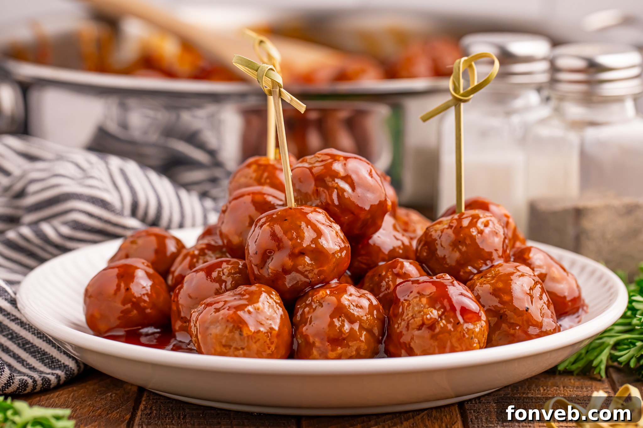 Plate of Peach BBQ Meatballs with toothpicks in some 