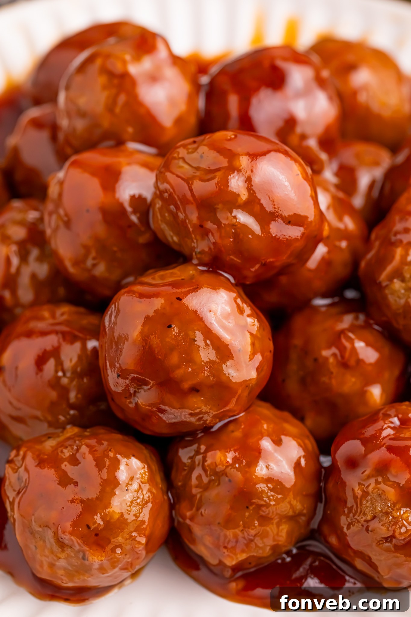 Up close shot of a white Plate of Peach BBQ Meatballs 