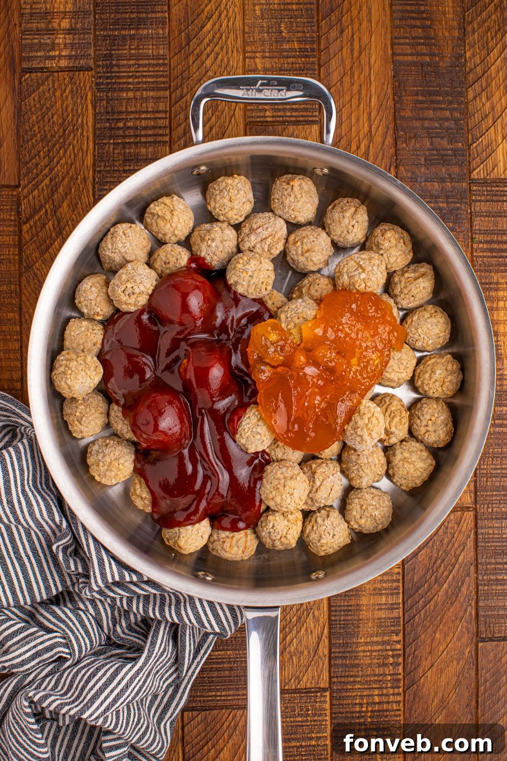 frozen meatballs in a skillet with sauce in it waiting to be cooked