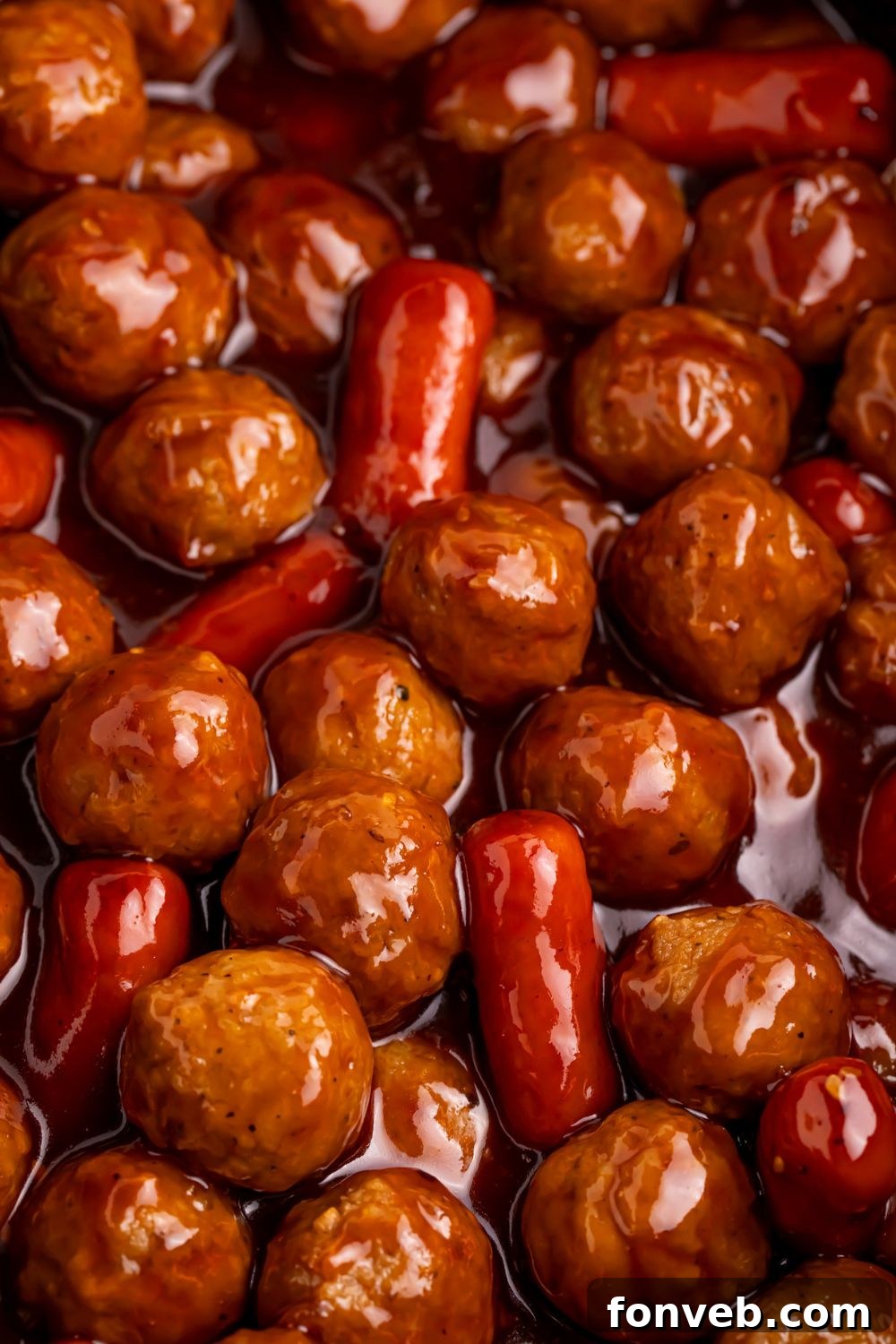 close up look of Crockpot Teriyaki BBQ Cocktail Meatballs & Lil Smokies in a crockpot on table 