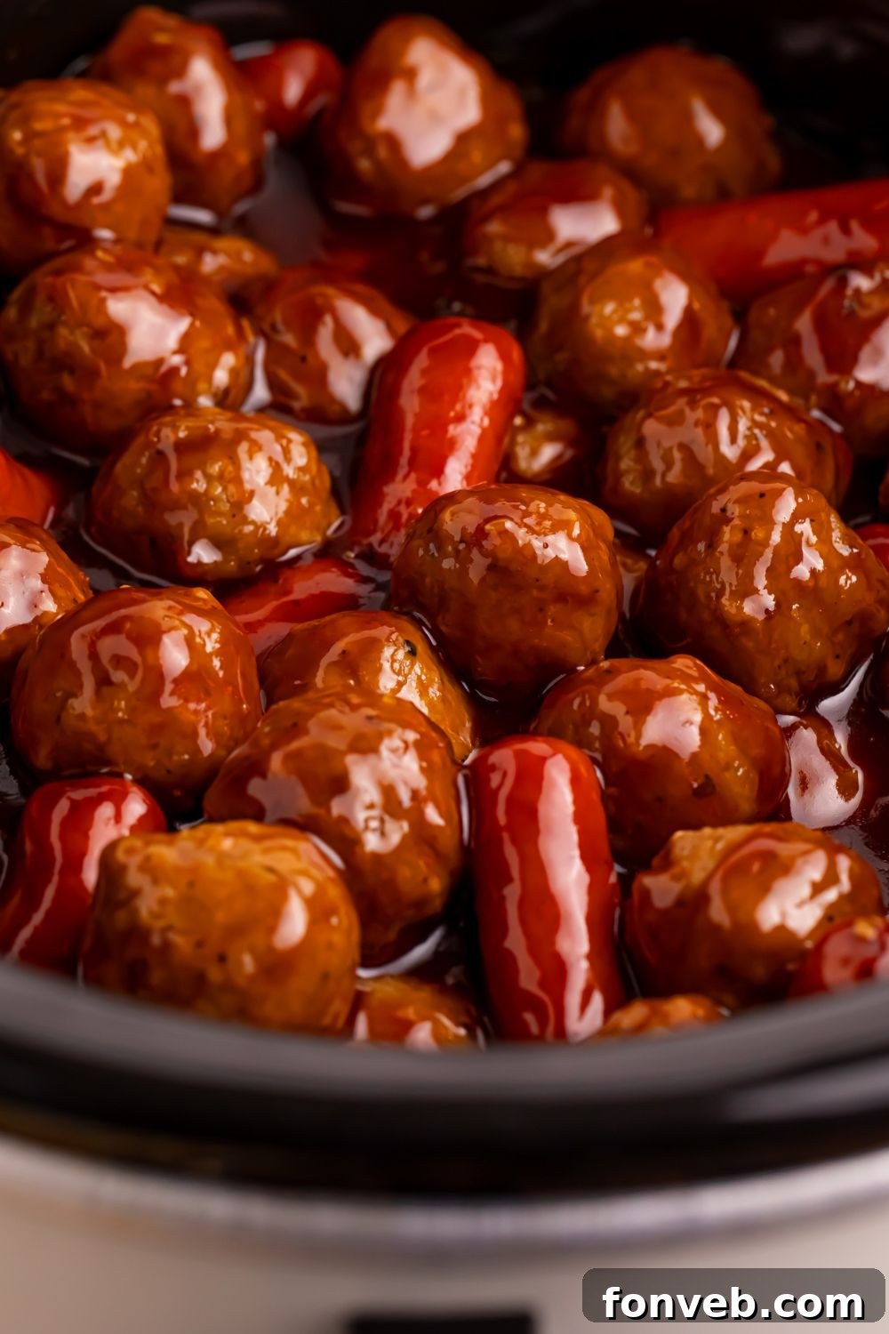 Crockpot Teriyaki BBQ Cocktail Meatballs & Lil Smokies in a crockpot showing a close up of the sauce coating all the meatballs and smokies 
