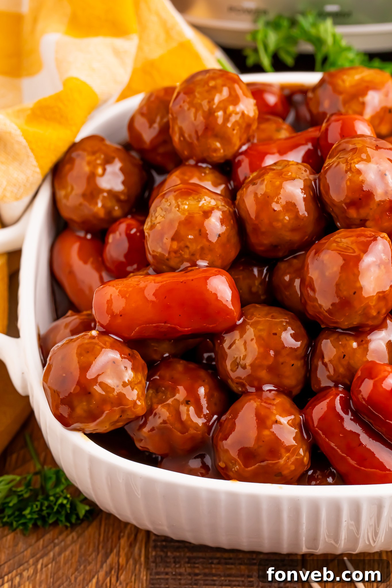 up close shot of Crockpot Teriyaki BBQ Cocktail Meatballs & Lil Smokies in a large white serving bowl 