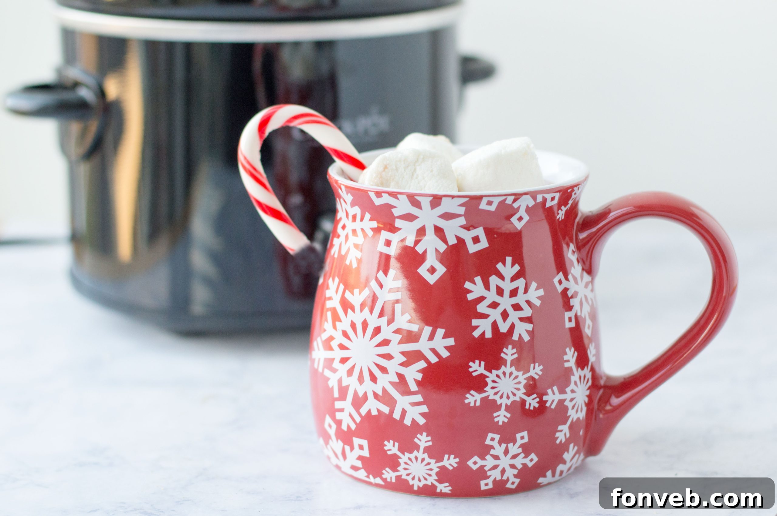 An inviting hot chocolate bar spread with a slow cooker, various toppings like whipped cream, marshmallows, and chocolate shavings.