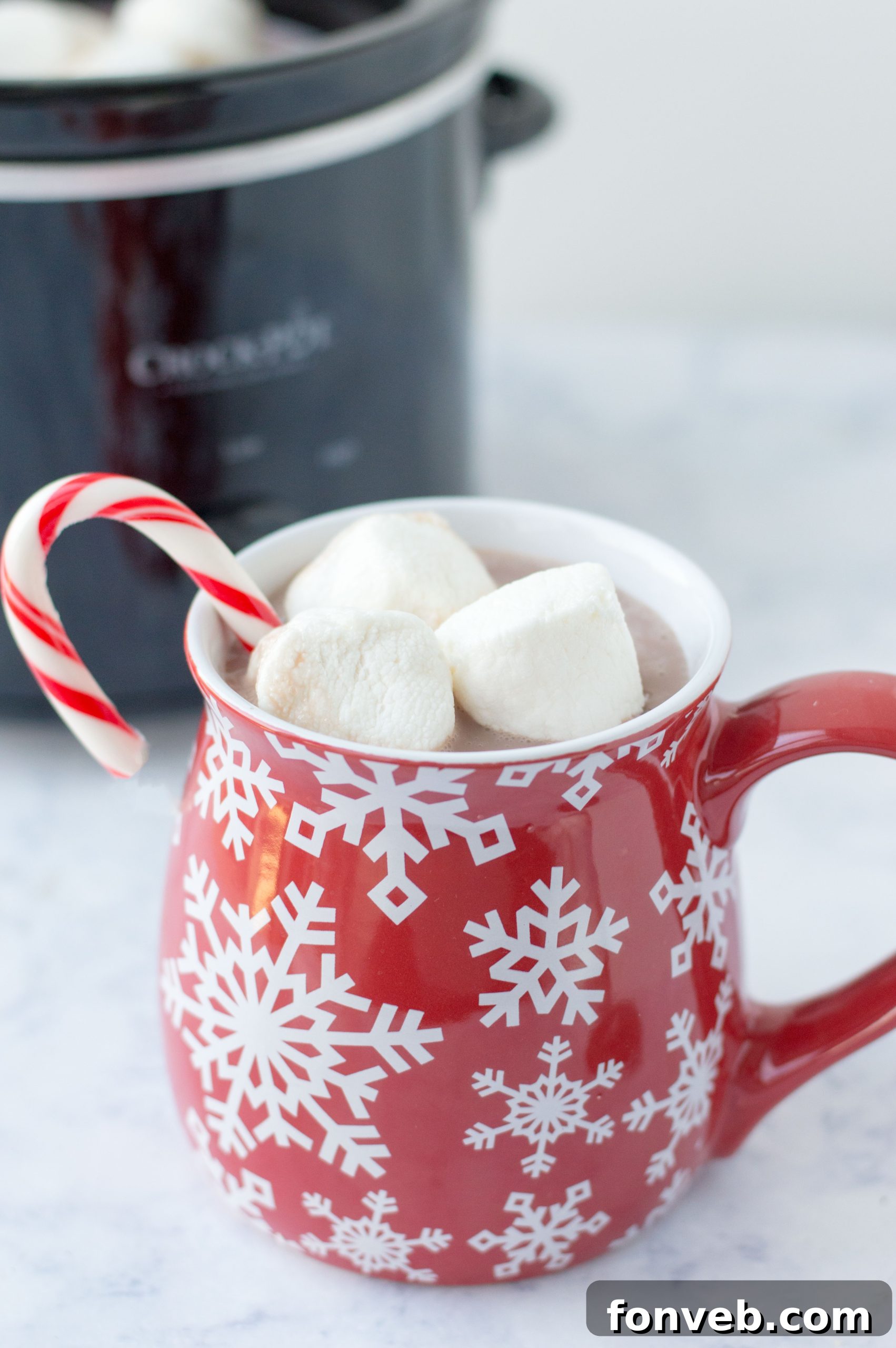 A close-up shot of rich, creamy slow cooker hot chocolate topped with fluffy marshmallows, perfect for a cozy treat.
