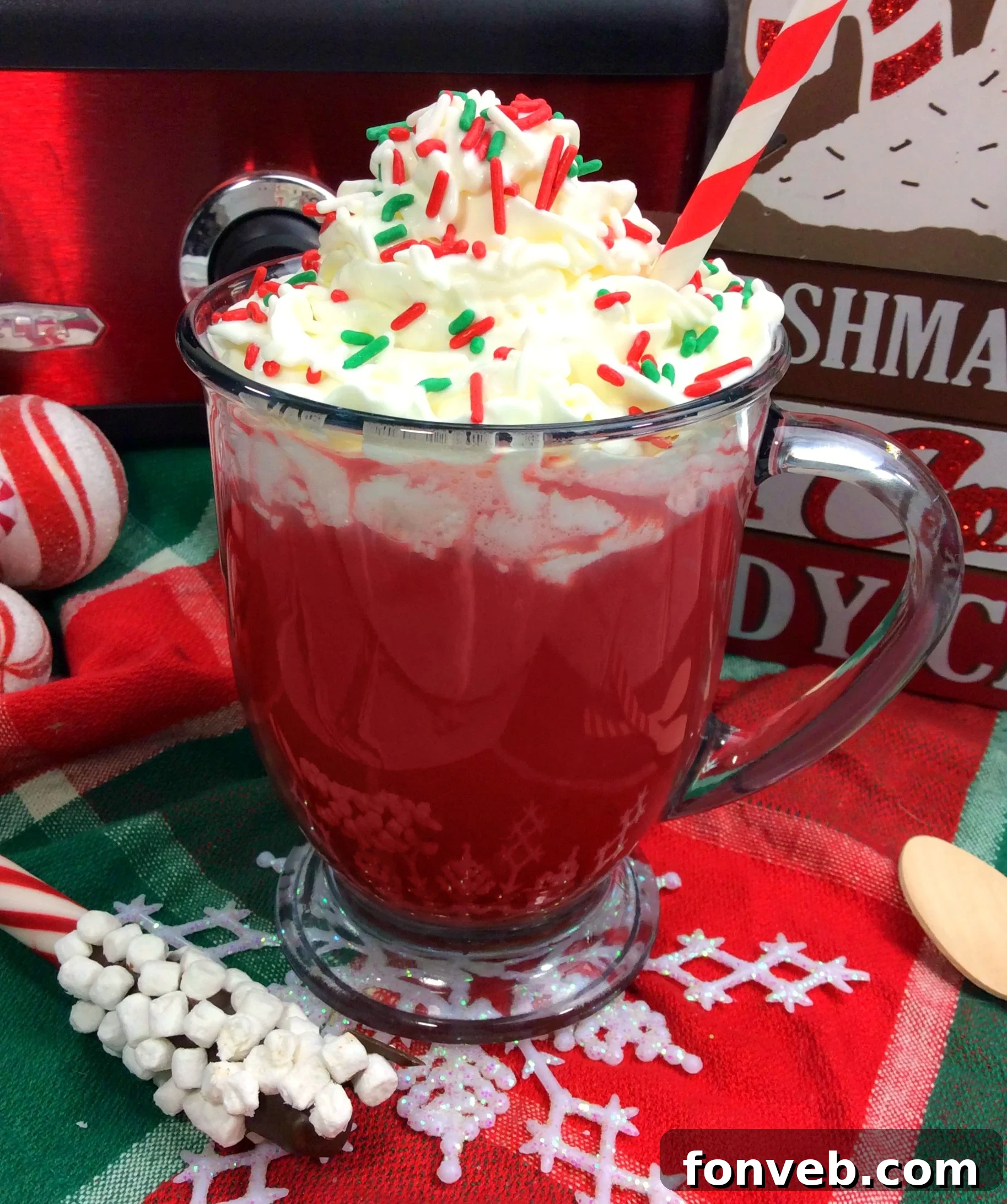 Rich and creamy Crock Pot Red Velvet Hot Chocolate, garnished with whipped cream and sprinkles, served in a festive mug.