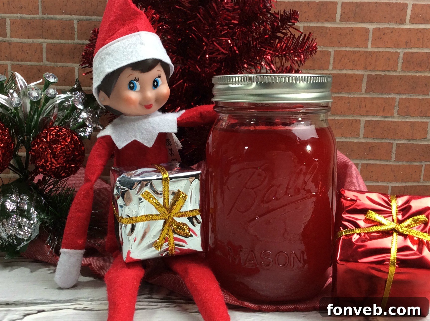 Enchanted Forest Brew 2 A festive glass of Elf Jungle Juice garnished with fresh berries and a lime slice, perfect for Christmas.