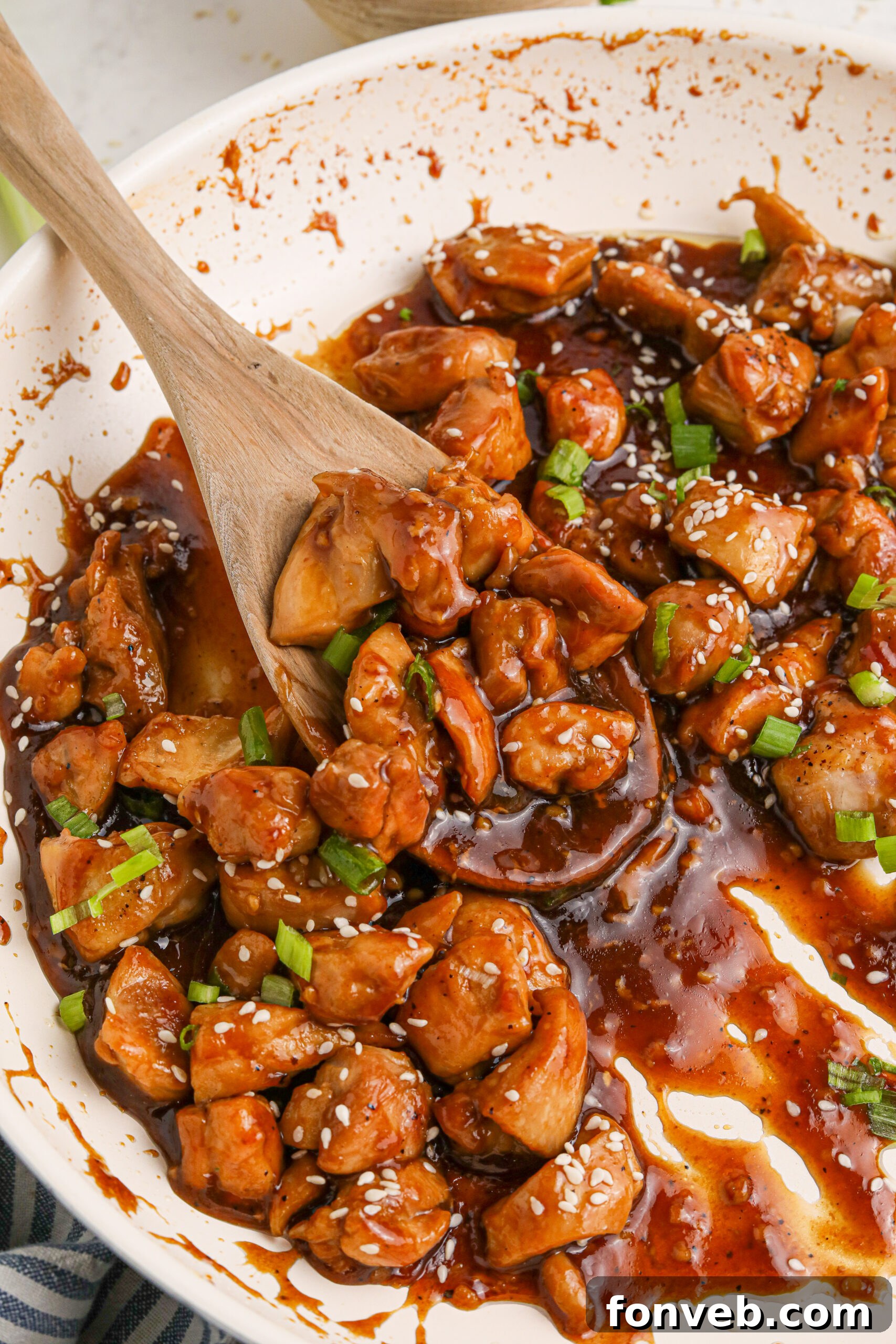 Irresistible Bourbon Chicken Skillet Quick Weeknight Win 24 Bourbon Chicken close up in a skillet with a spoon scooping some up