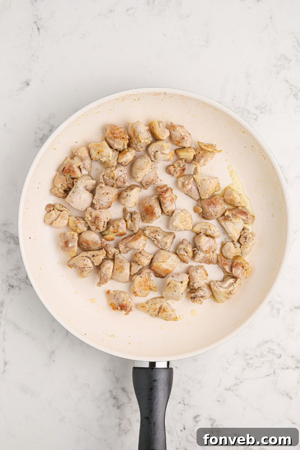 Irresistible Bourbon Chicken Skillet Quick Weeknight Win 8 skillet of diced chicken on a marble counter