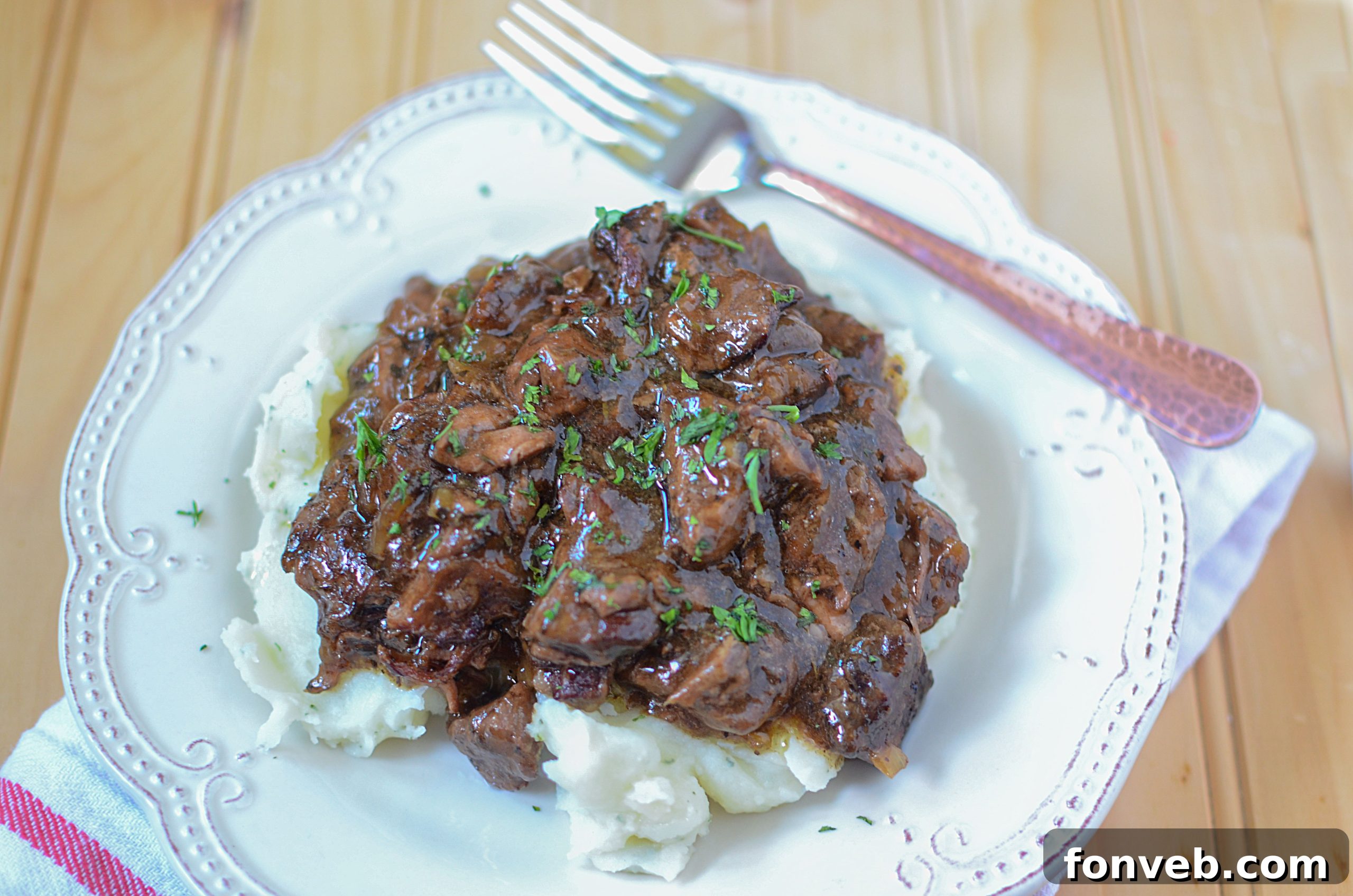 Melt-in-Your-Mouth Slow Cooker Sirloin Beef Tips Smothered in Rich Mushroom Gravy 4 Raw sirloin beef tips being prepared in a skillet before going into the slow cooker.