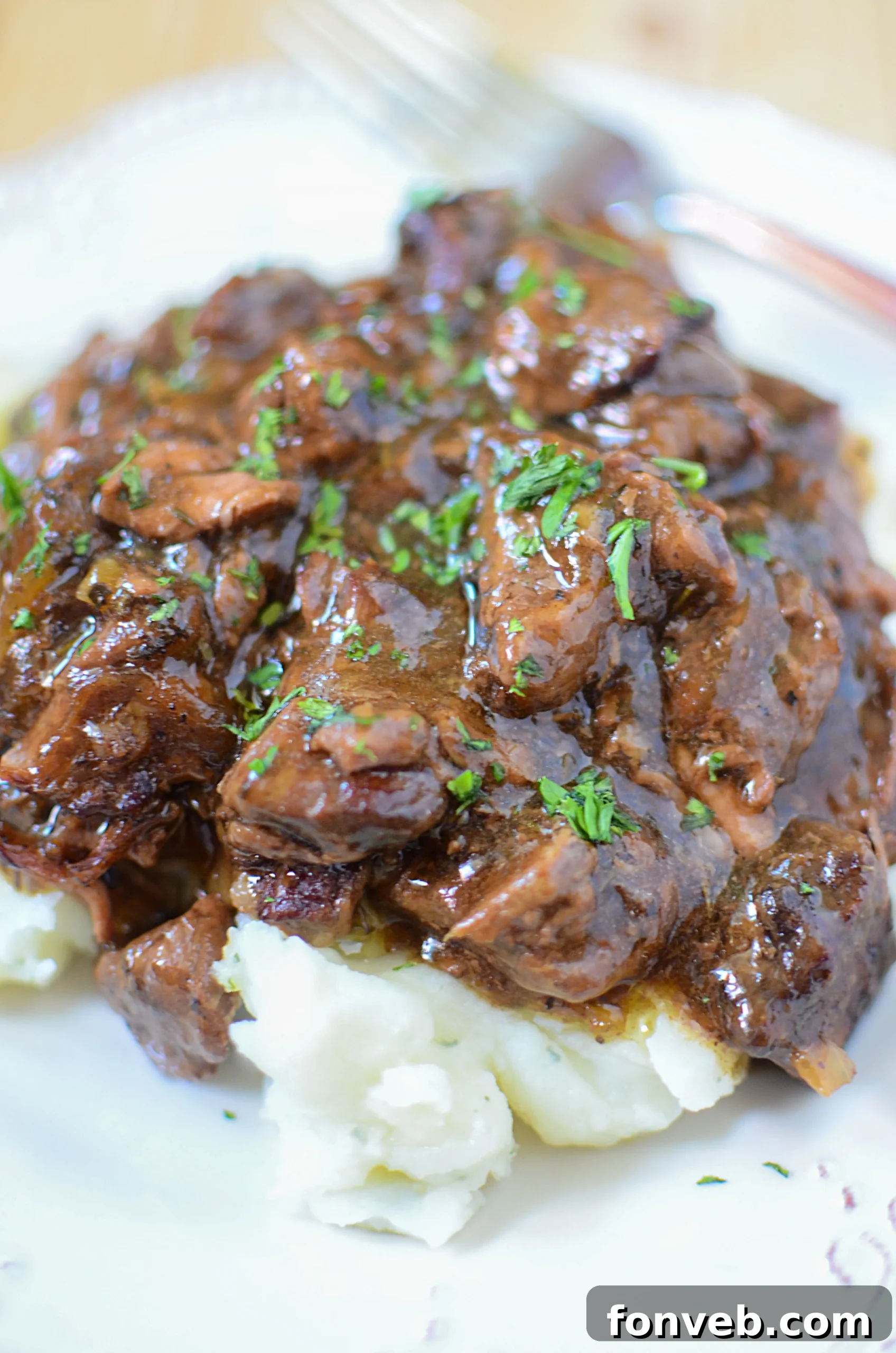Melt-in-Your-Mouth Slow Cooker Sirloin Beef Tips Smothered in Rich Mushroom Gravy 5 Generous portion of Slow Cooker Sirloin Beef Tips in Mushroom Gravy served on a plate.