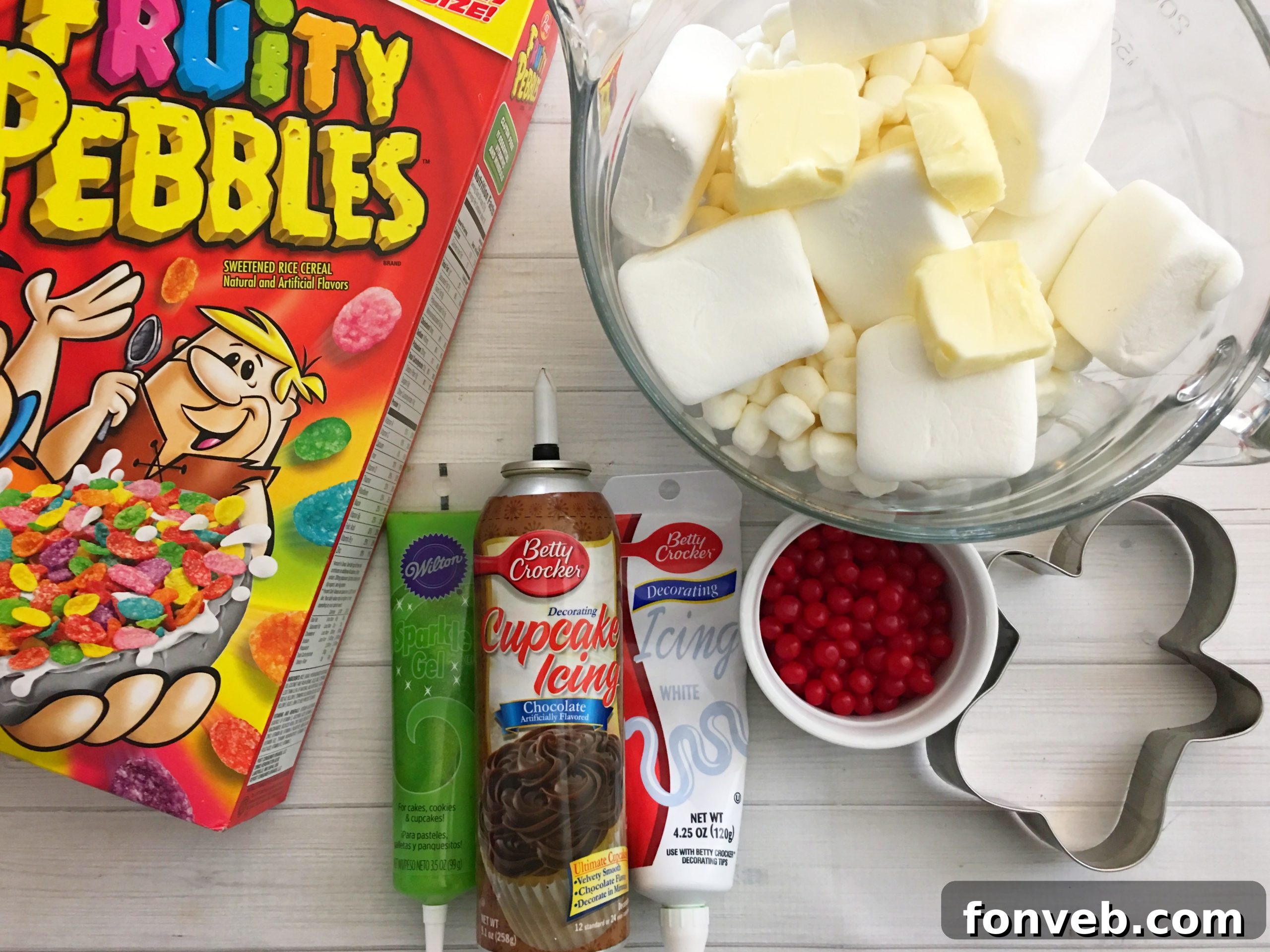 Close-up of Fruity Pebbles Krispy Treats mixture being pressed into a baking pan.