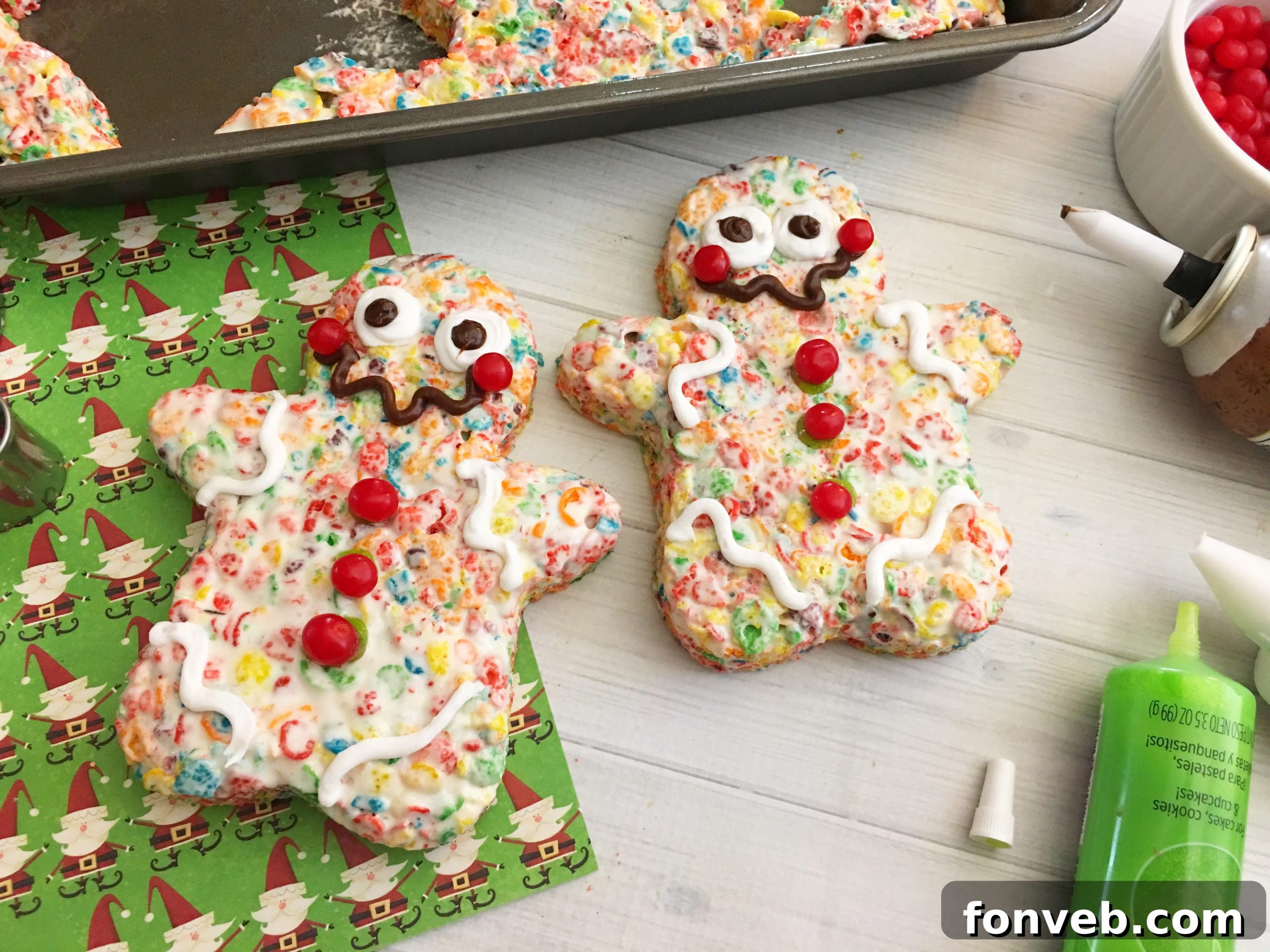 A batch of freshly made and decorated Fruity Pebbles Krispy Treats in various stages, showing their colorful appeal.