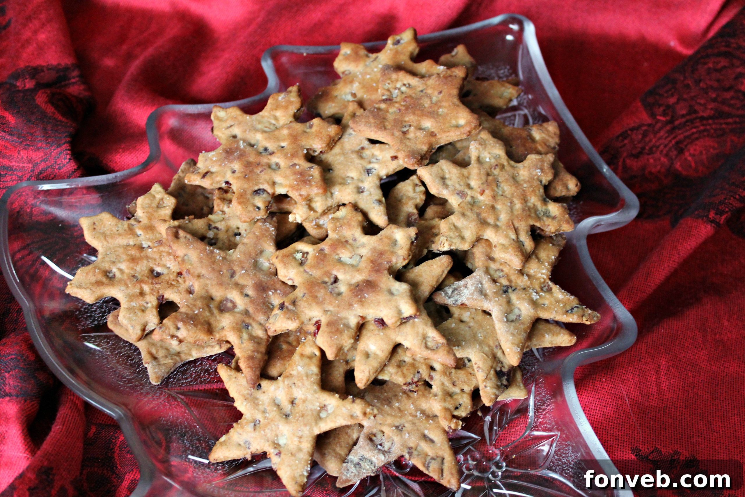 Gourmet Bacon Pecan Crisps 4 Various cracker shapes cut out from the dough, ready for baking on a parchment-lined sheet.